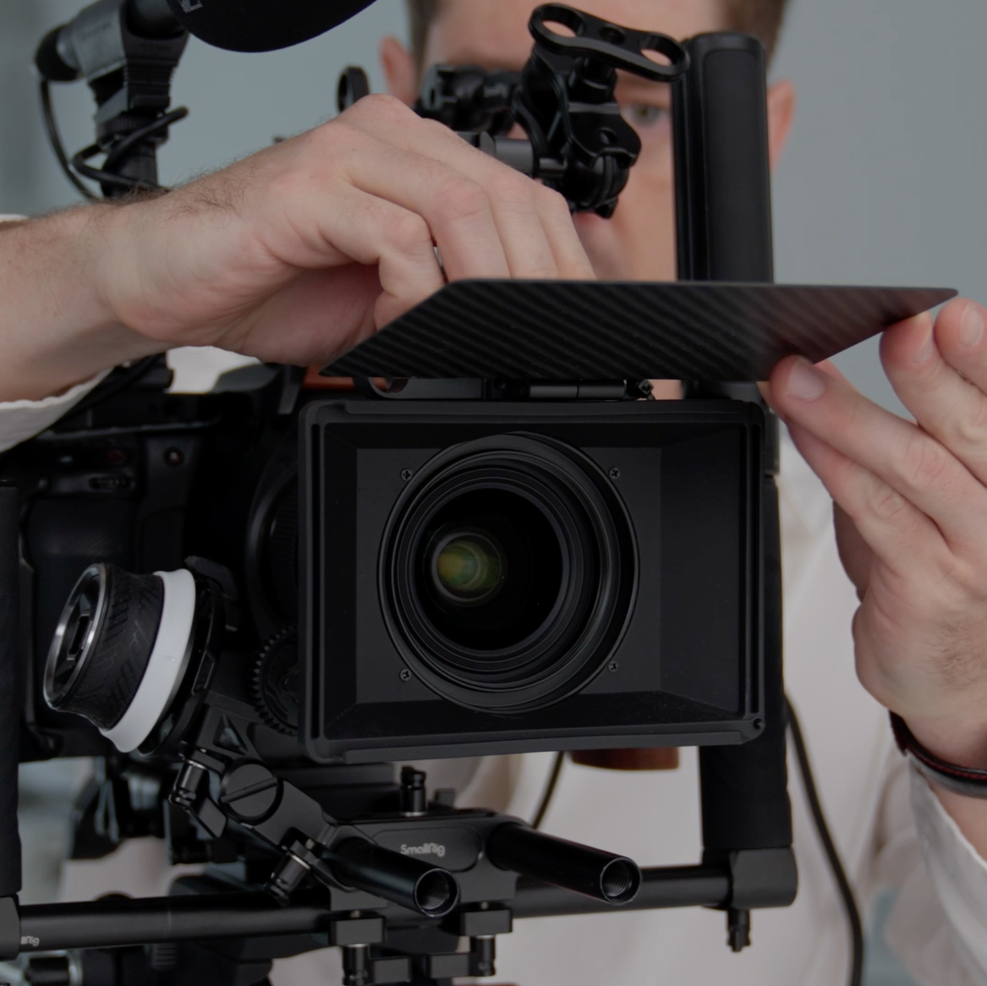 Videographer adjusting a professional cinema camera during a commercial shoot