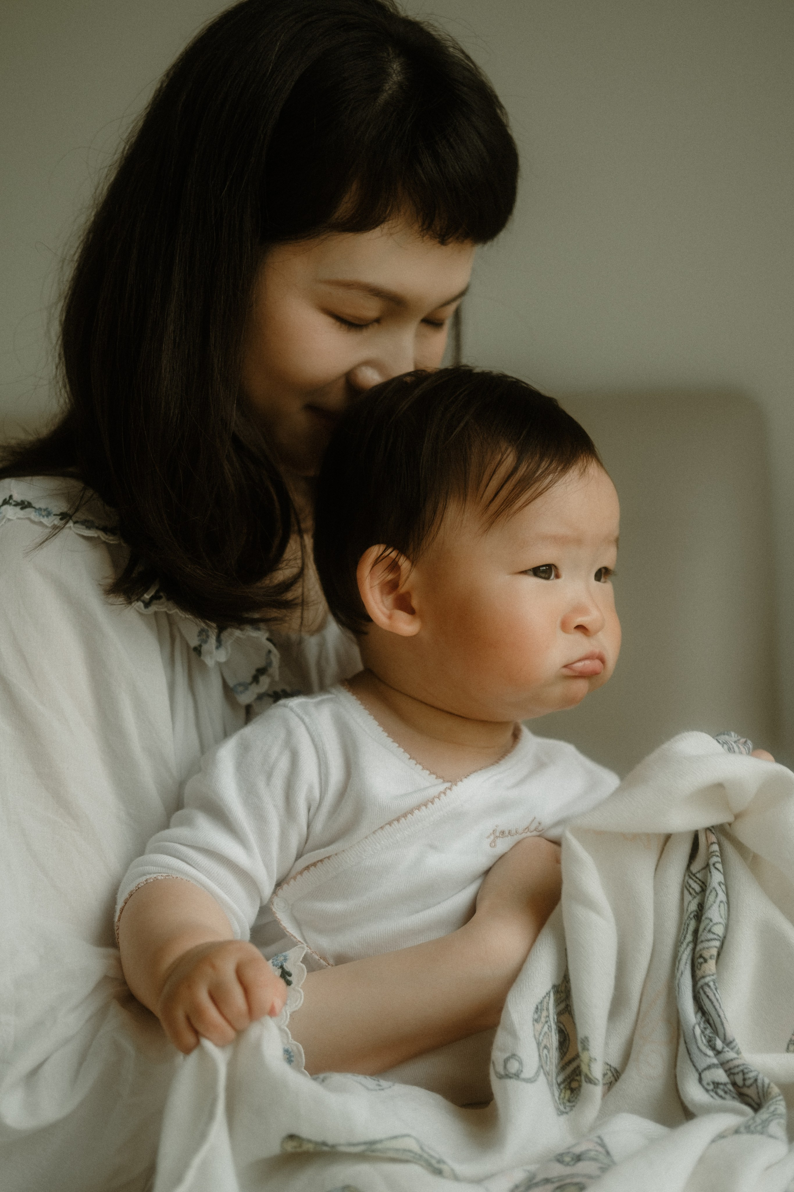 Young mom holding her baby in her arms in Richmond, VA