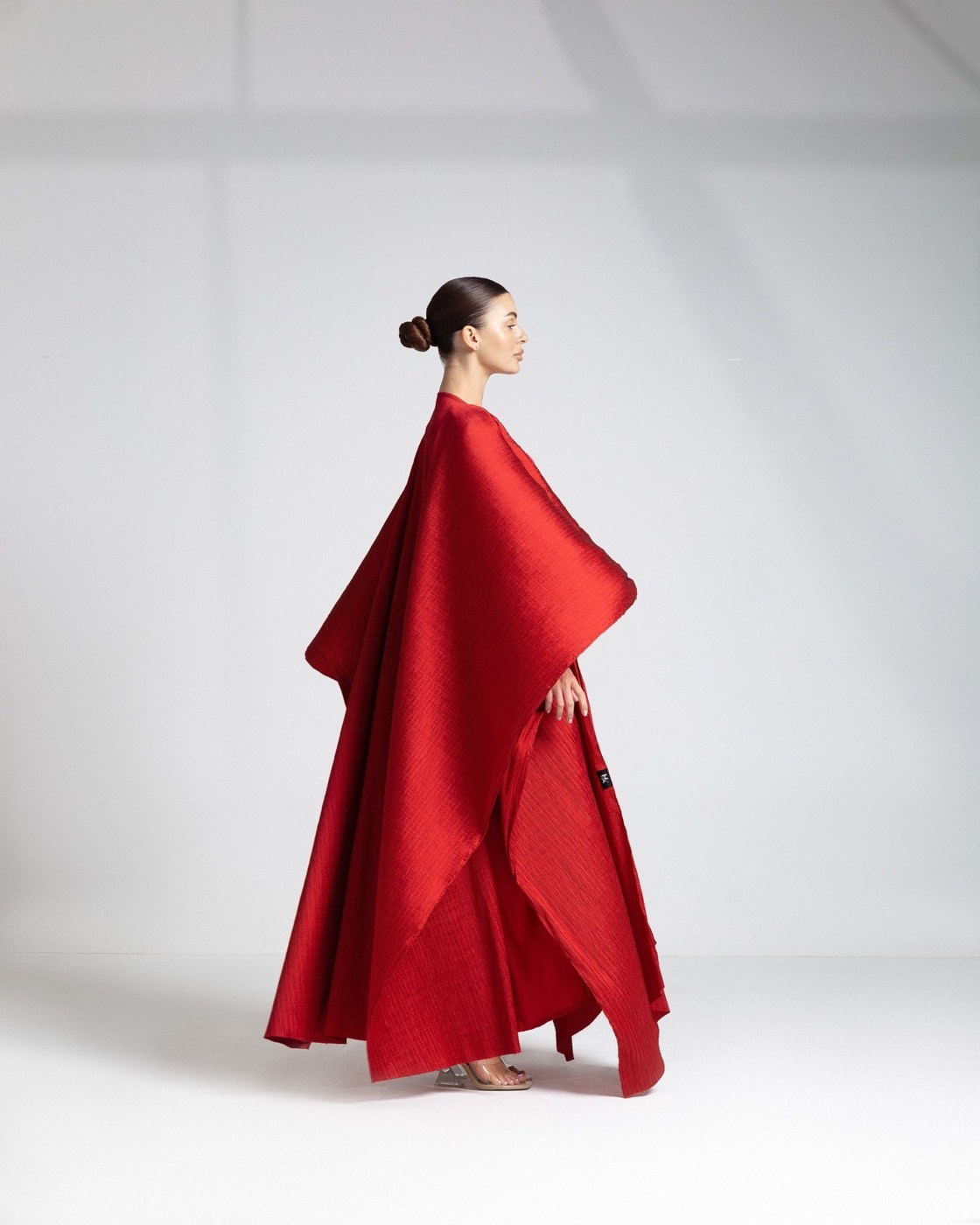 Fashion model in a flowing red dress photographed for a creative campaign