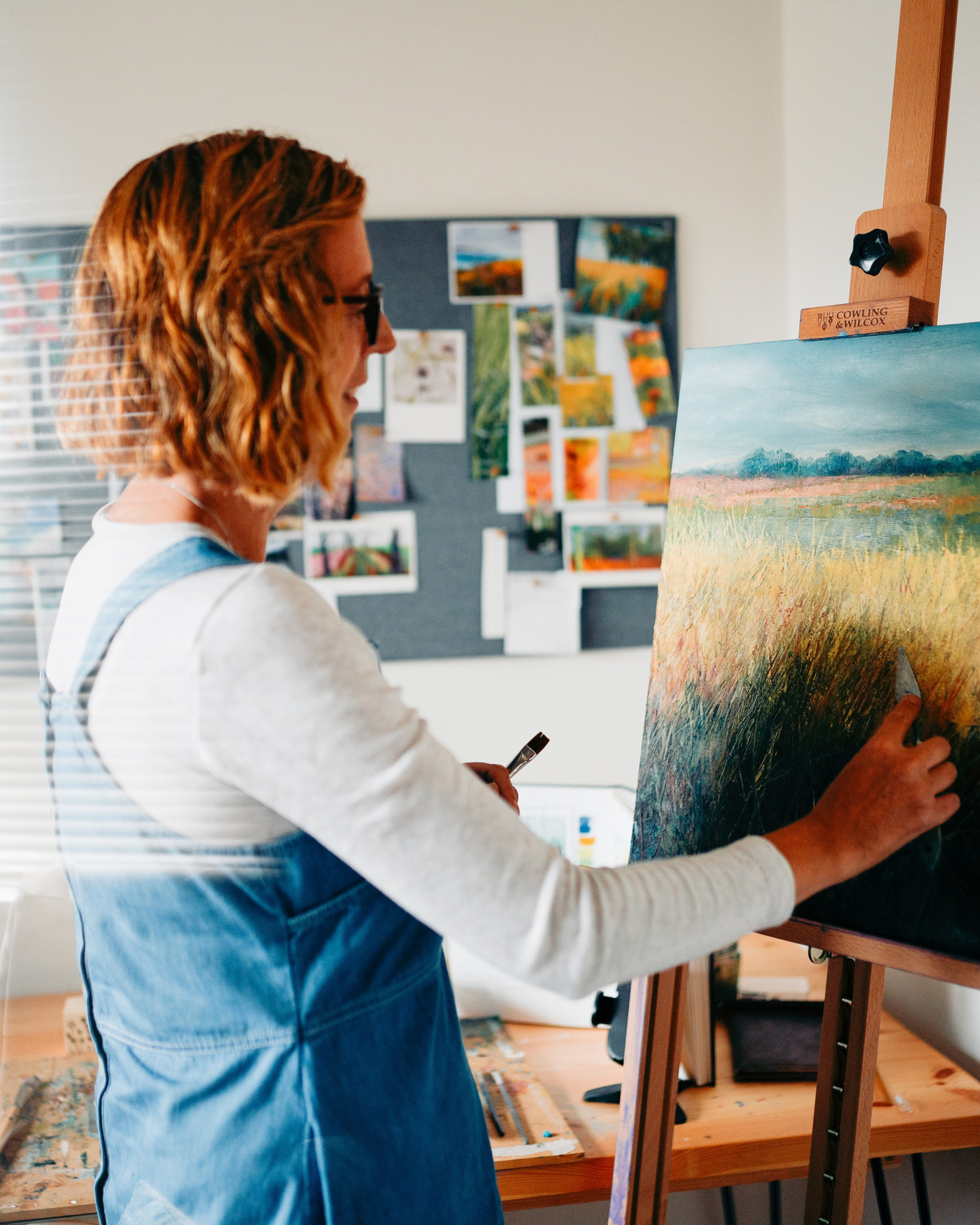 Creative brand photography of an artist painting in her studio in Solihull, capturing process and personality.