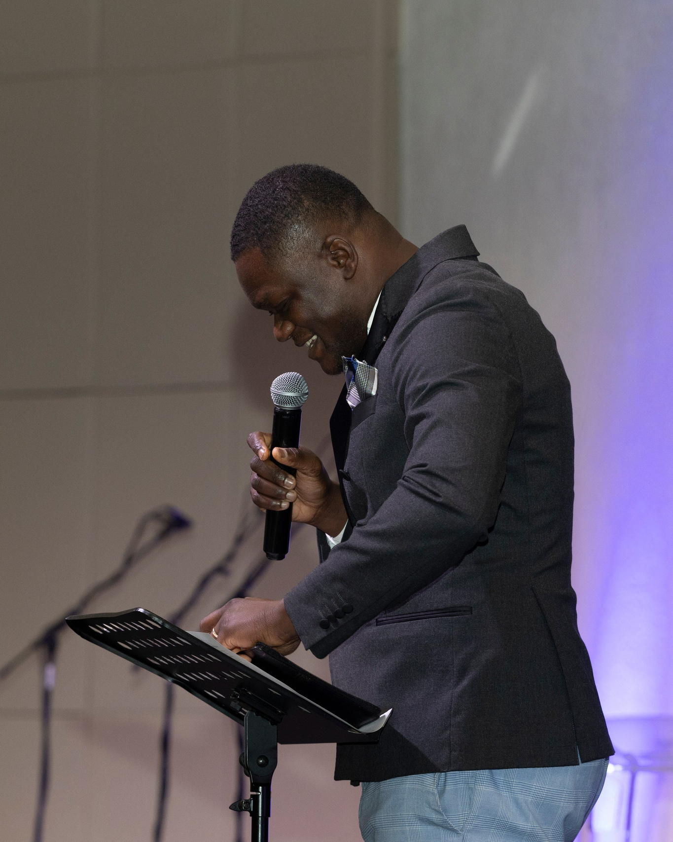 speaker holding a microphone during a corporate event