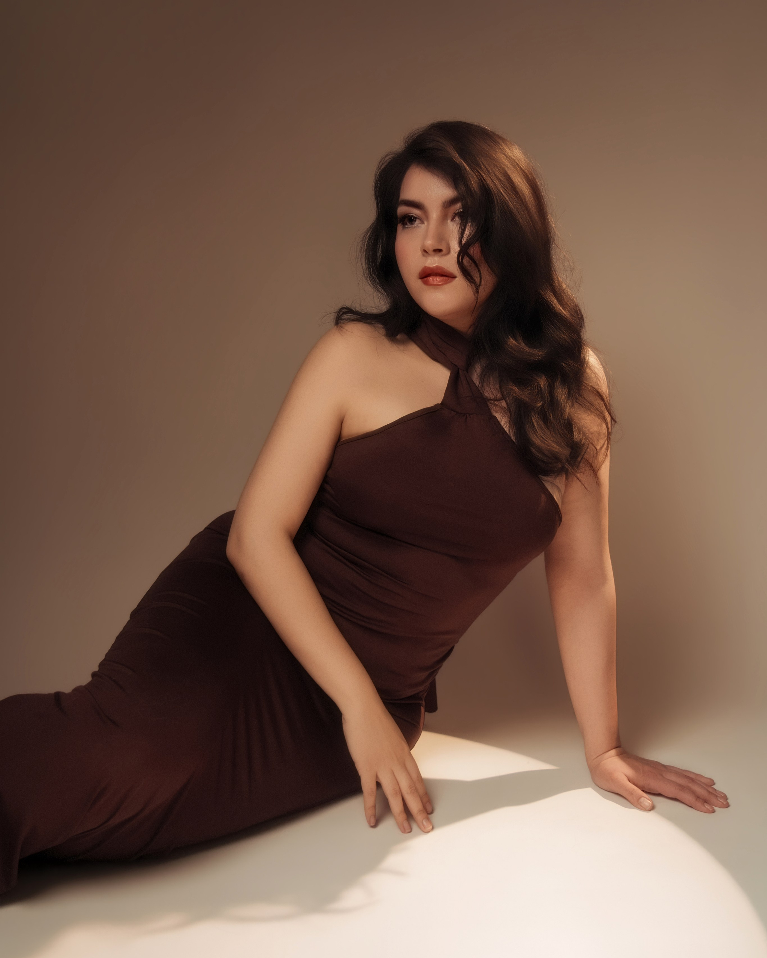 Connecticut womens portrait, woman reclining in brown halter dress, sensual editorial style.