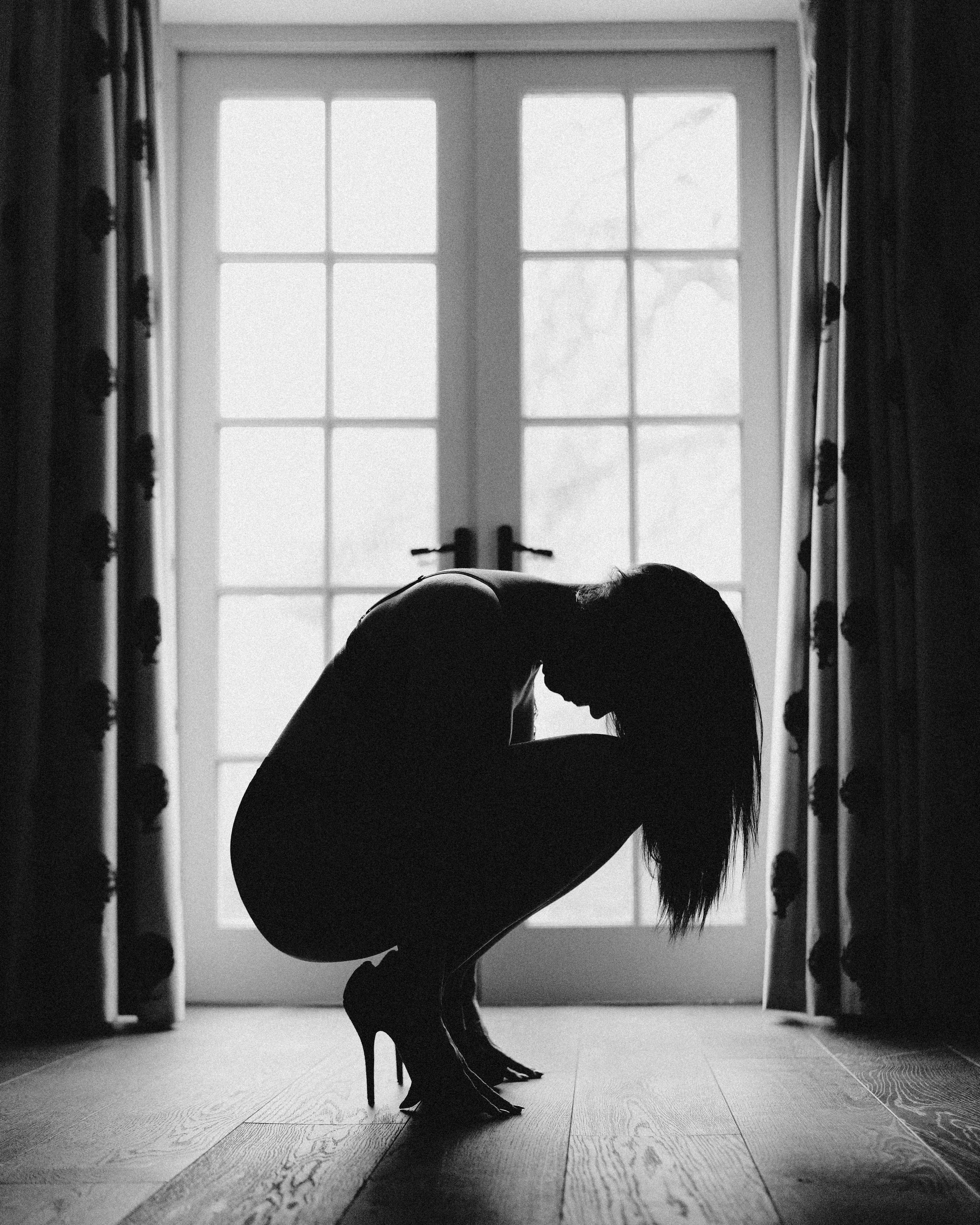 Intimate fine art boudoir portrait in soft shadow and gentle light