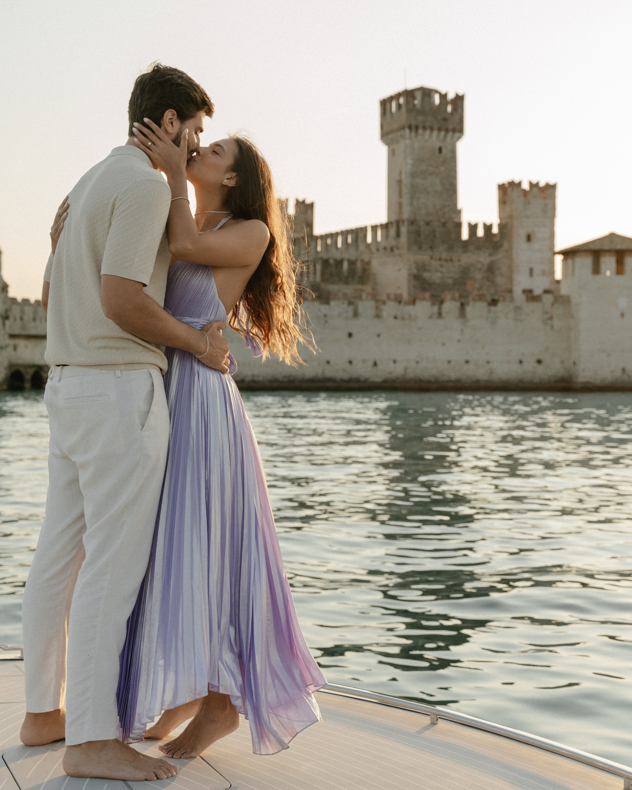 Marriage proposal at Lake Garda on a wooden boat at sunset, around Sirmione