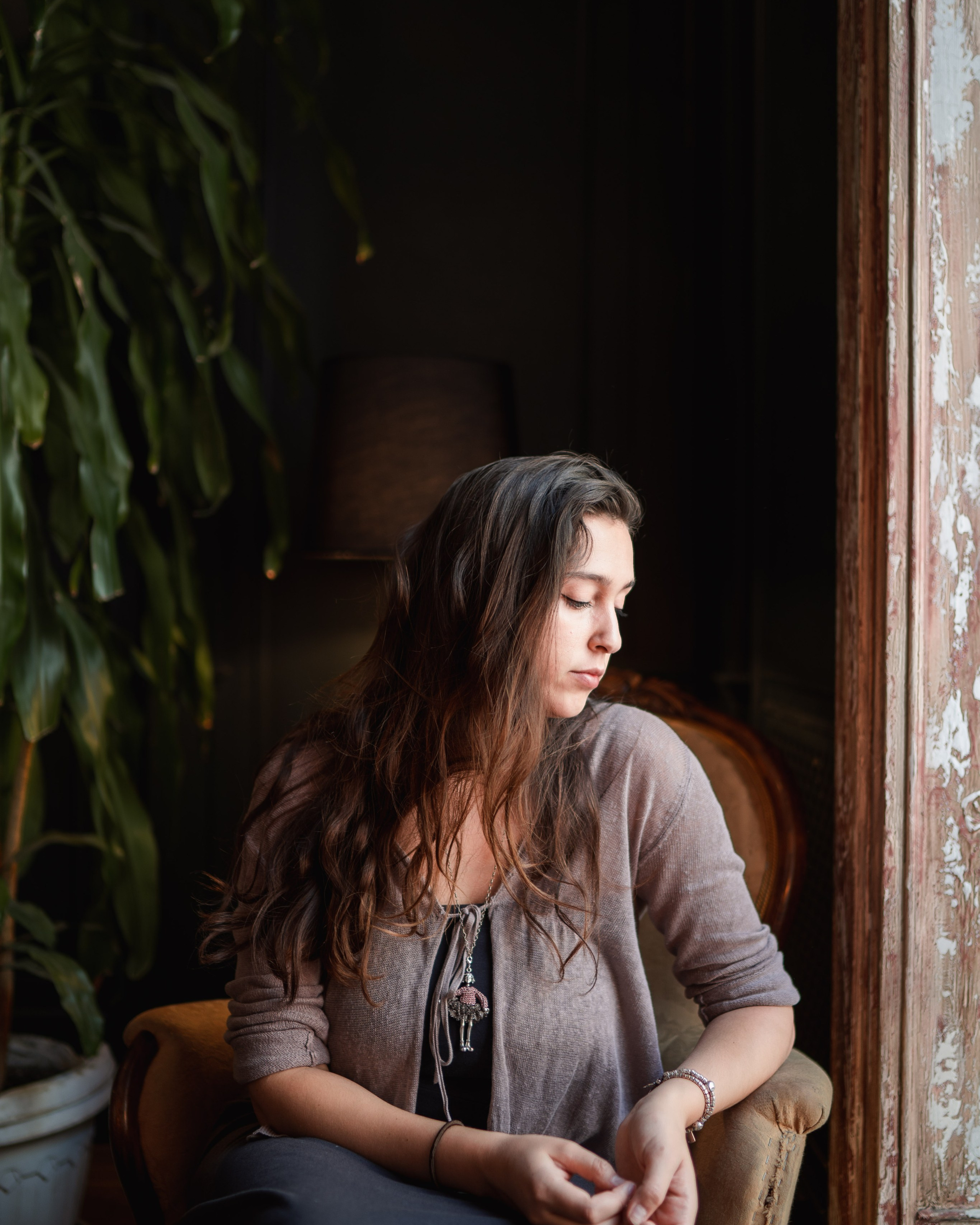 Girl sitting next to the window in the morning.