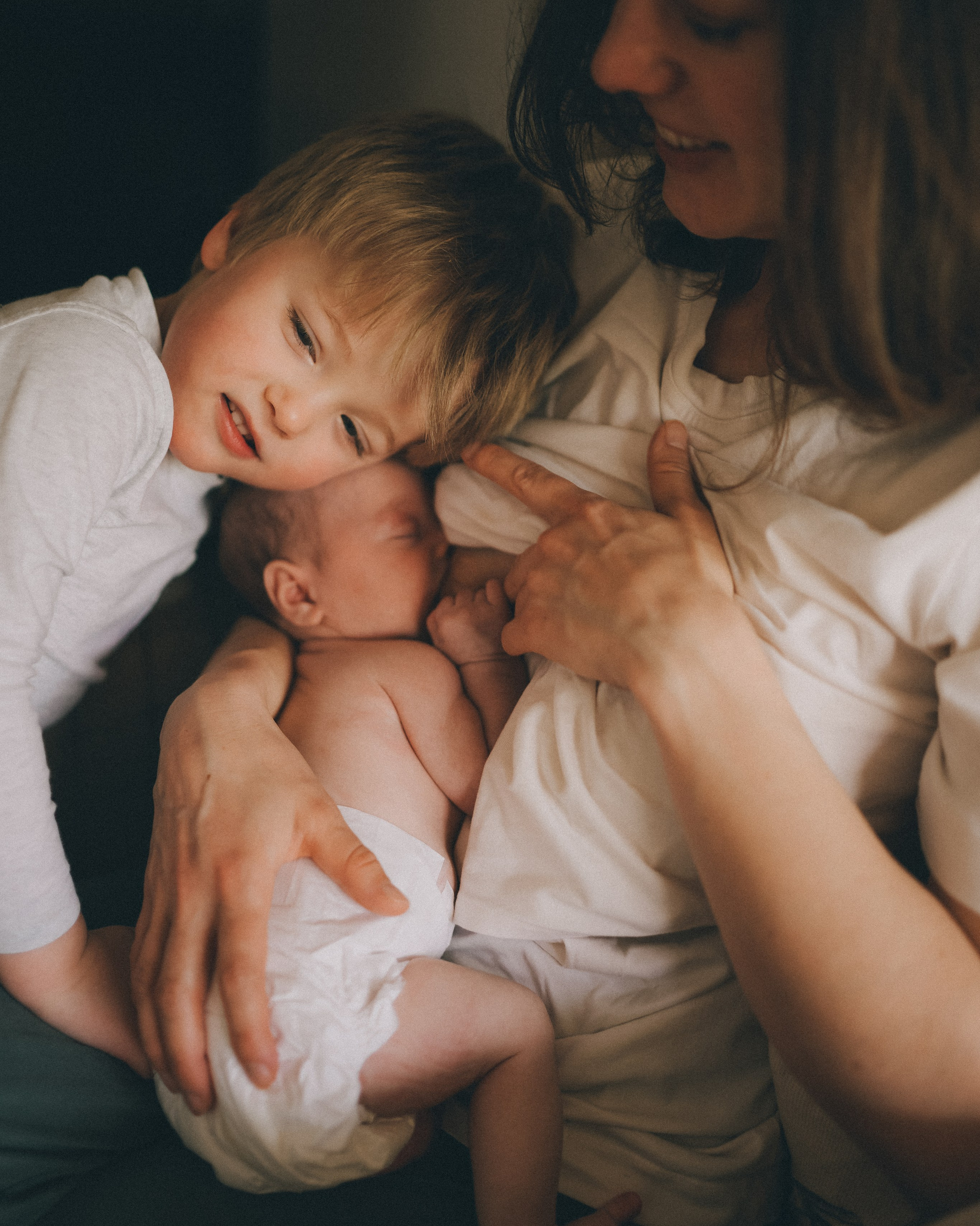 At-home newborn photo session in Solihull with Irina Zoteeva. Mum is holding baby's feet.