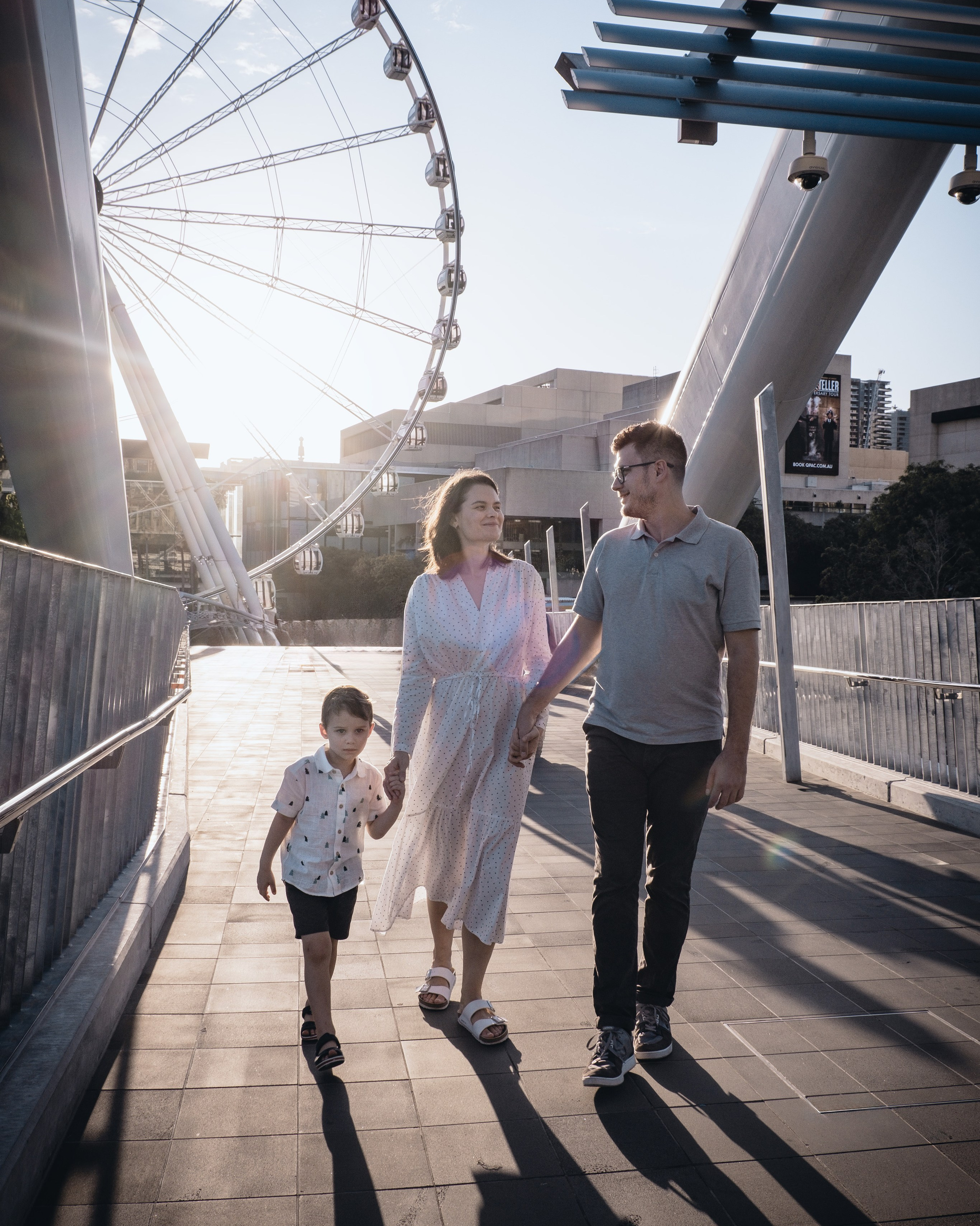 Family walking on a modern city bridge, Family & lifestyle photography in Brisbane