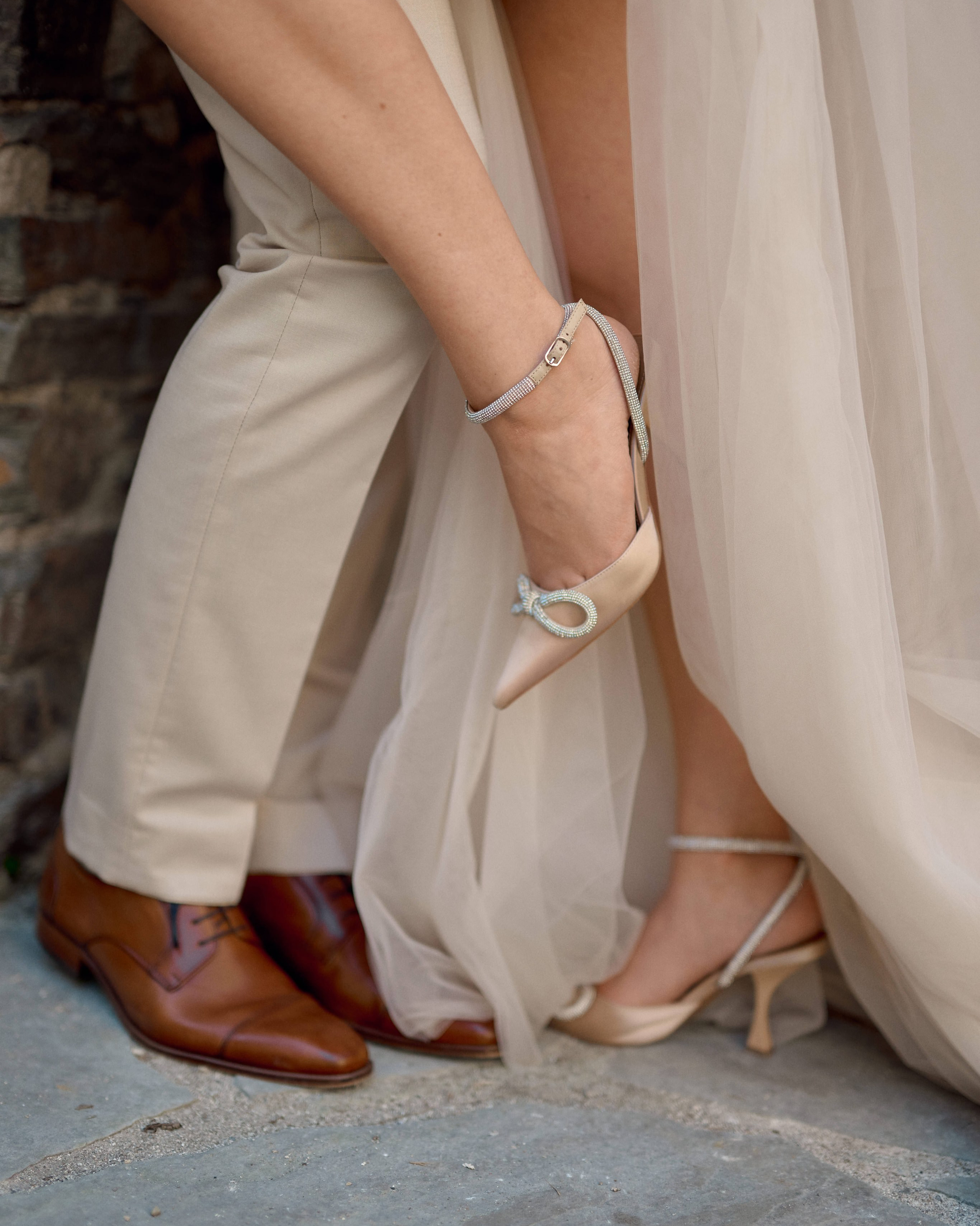 Detailaufnahme von eleganten Brautschuhen mit Schleife und stilvollen Herrenschuhen bei einem Hochzeitsshooting in Bonn, fotografiert von Alex Fetter.