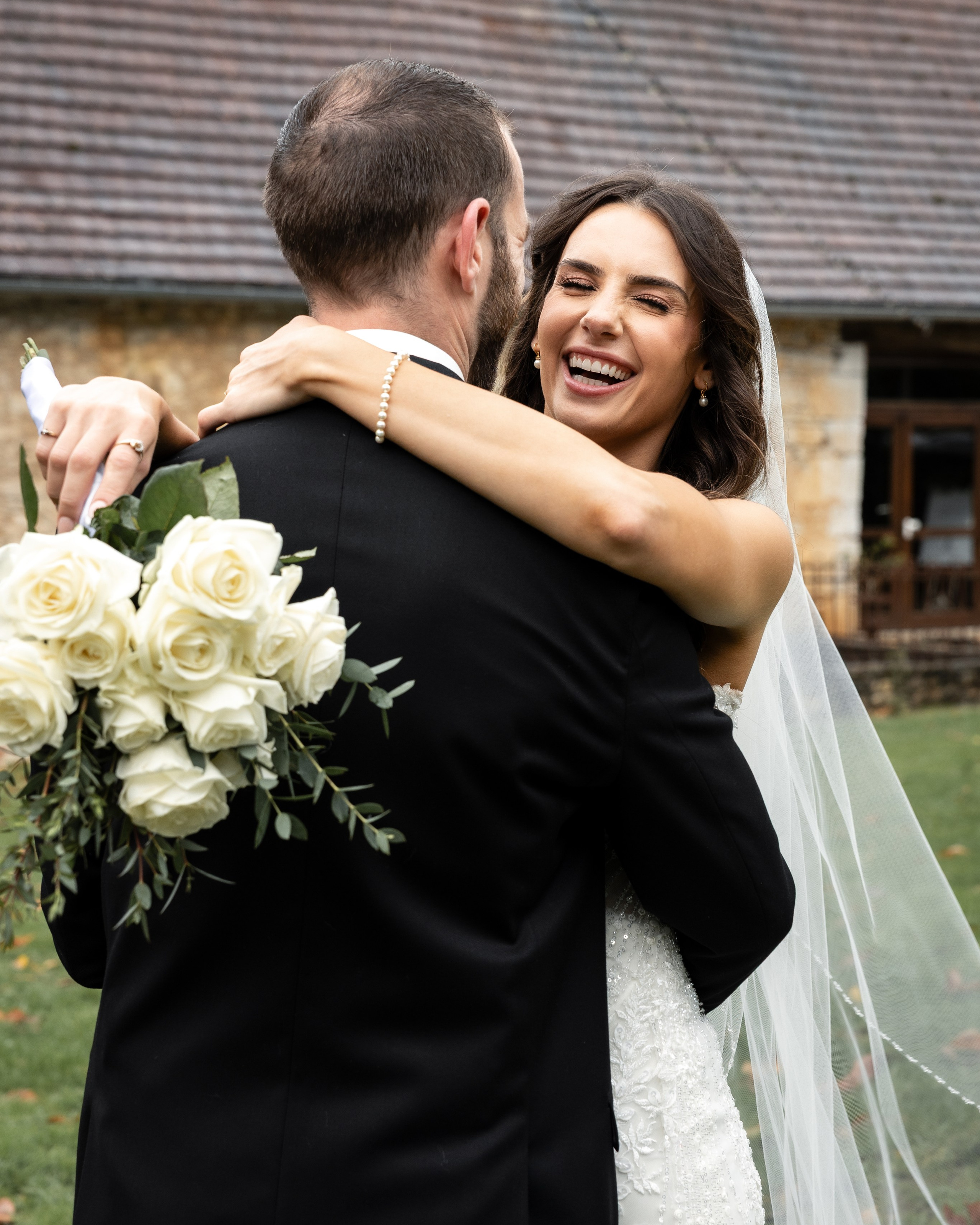 Château wedding in Dordogne with bride and groom in front of historic stone estate.