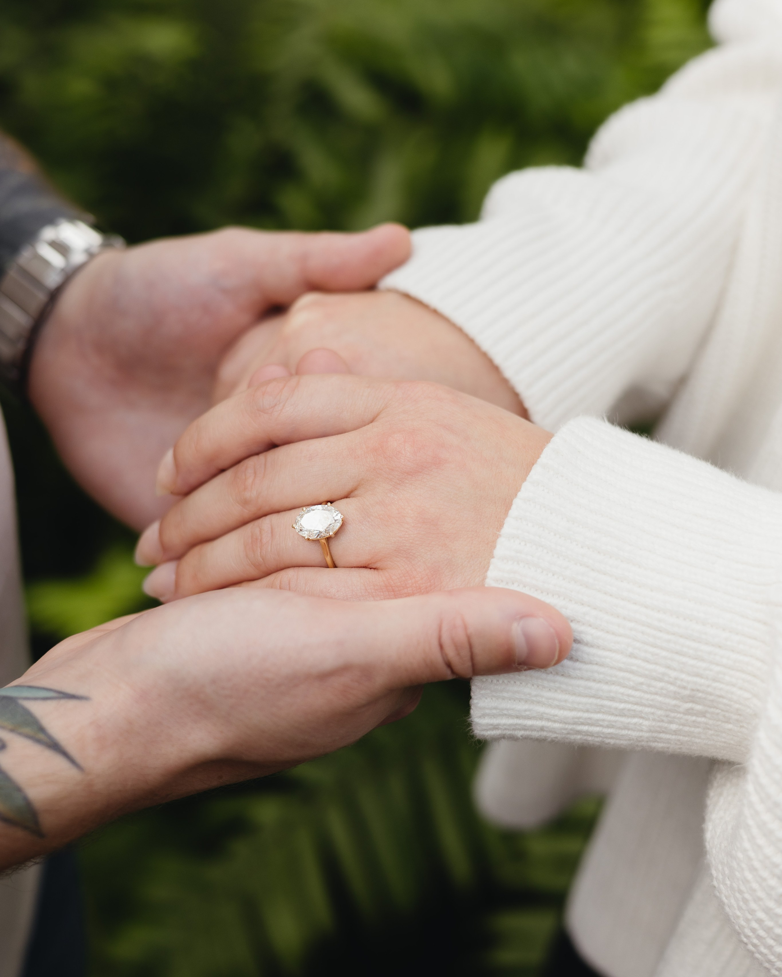 Happy couple embracing after proposal at Garfield Park Conservatory