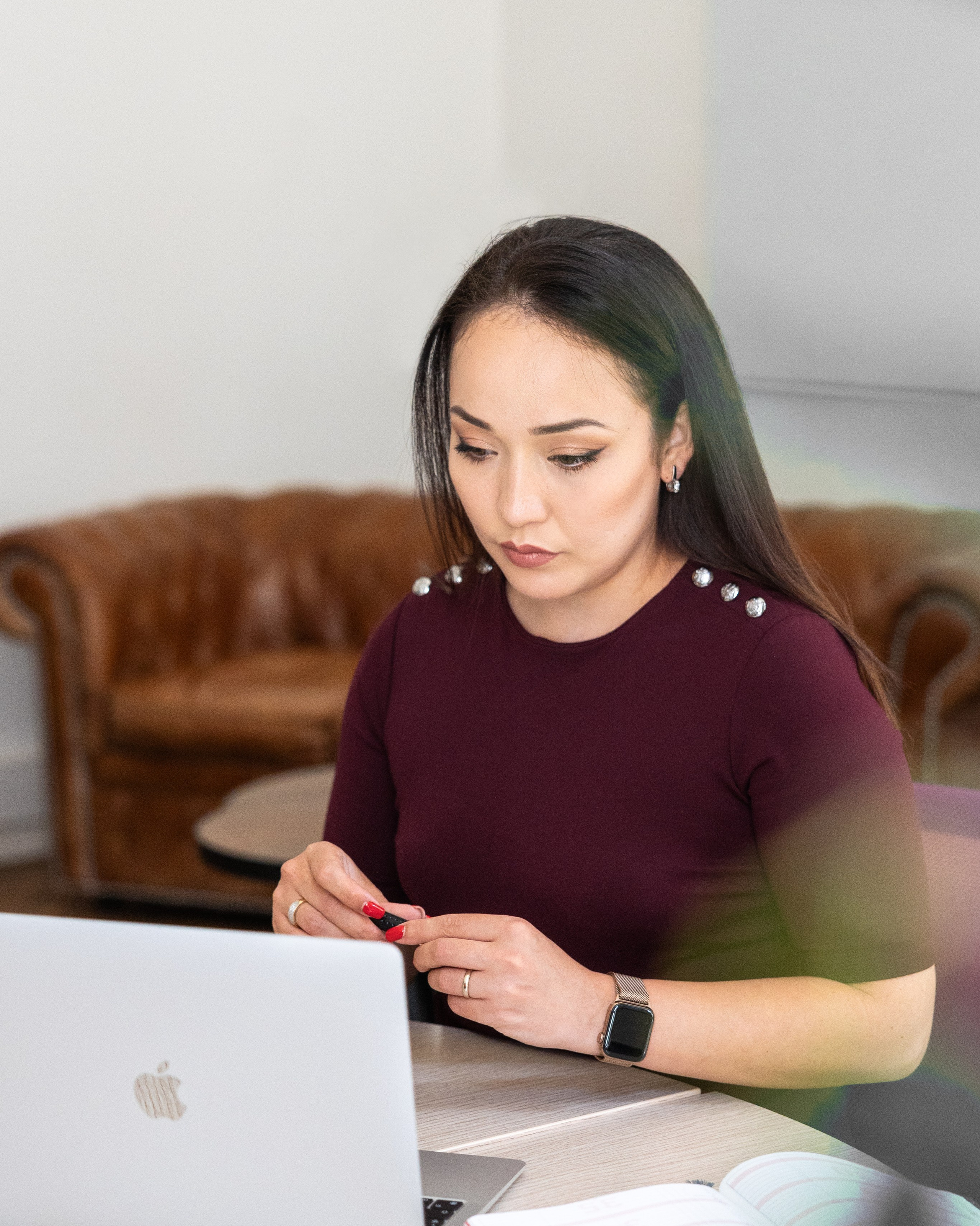 professional portrait of a woman working on a laptop in a bright interior during a corporate photo session