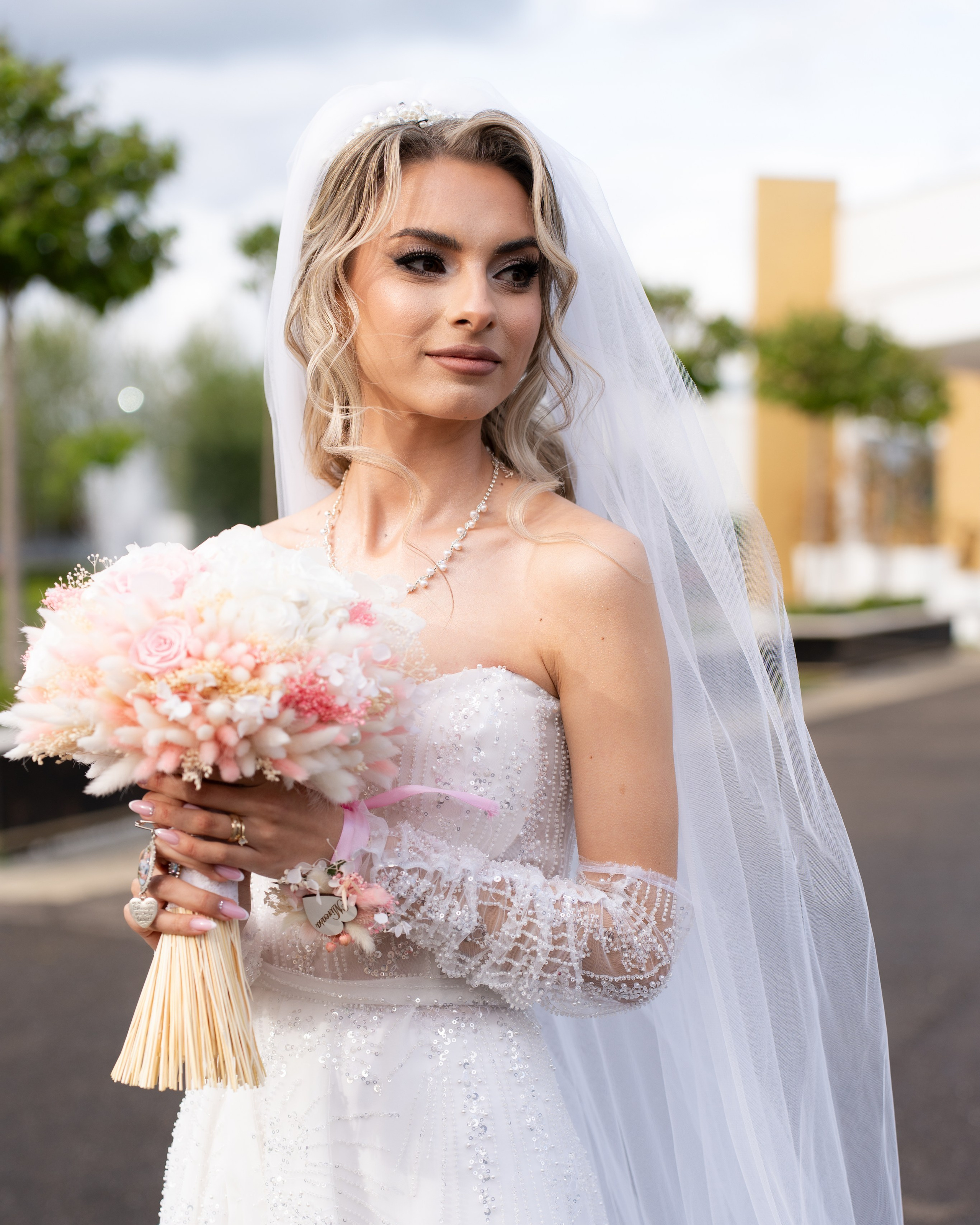Portret artistic al Andreei, o mireasă superbă cu voal, în momentul de liniște dintre biserică și petrecere la Restaurantul „La Livada” din Vaslui. Fotografie de nuntă realizată de Lucian Murgeanu.