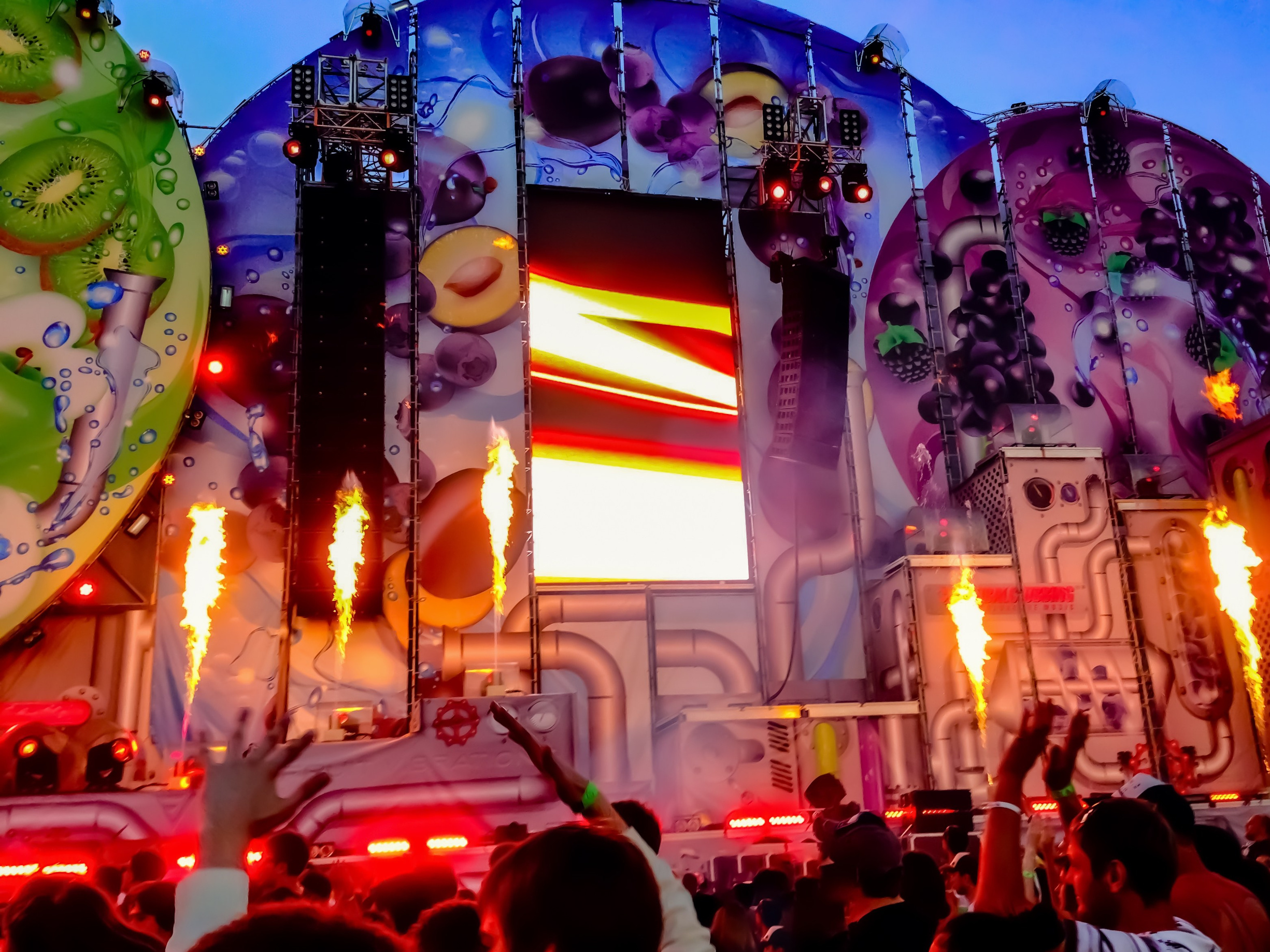 Reportage photo of a music festival stage with special effects, captured from the audience perspective