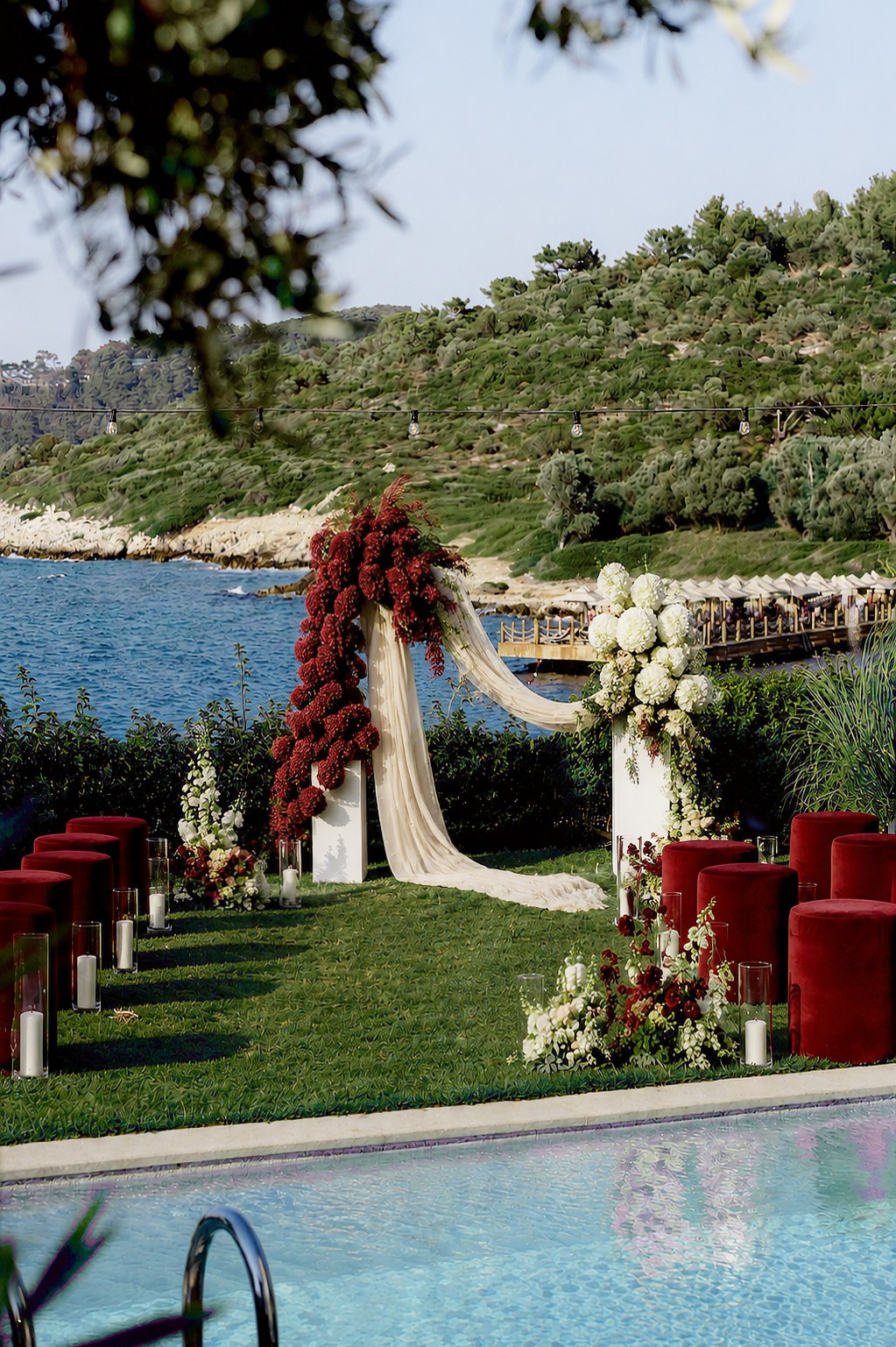 Romantic outdoor wedding ceremony in Bodrum with burgundy and white flowers by the Aegean Sea