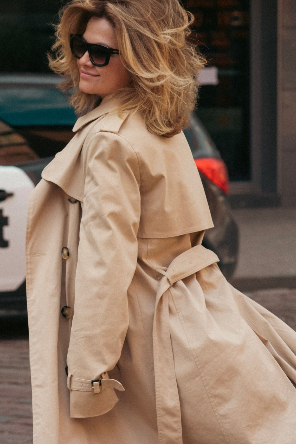 A sad girl sits and looks out the window – color portrait