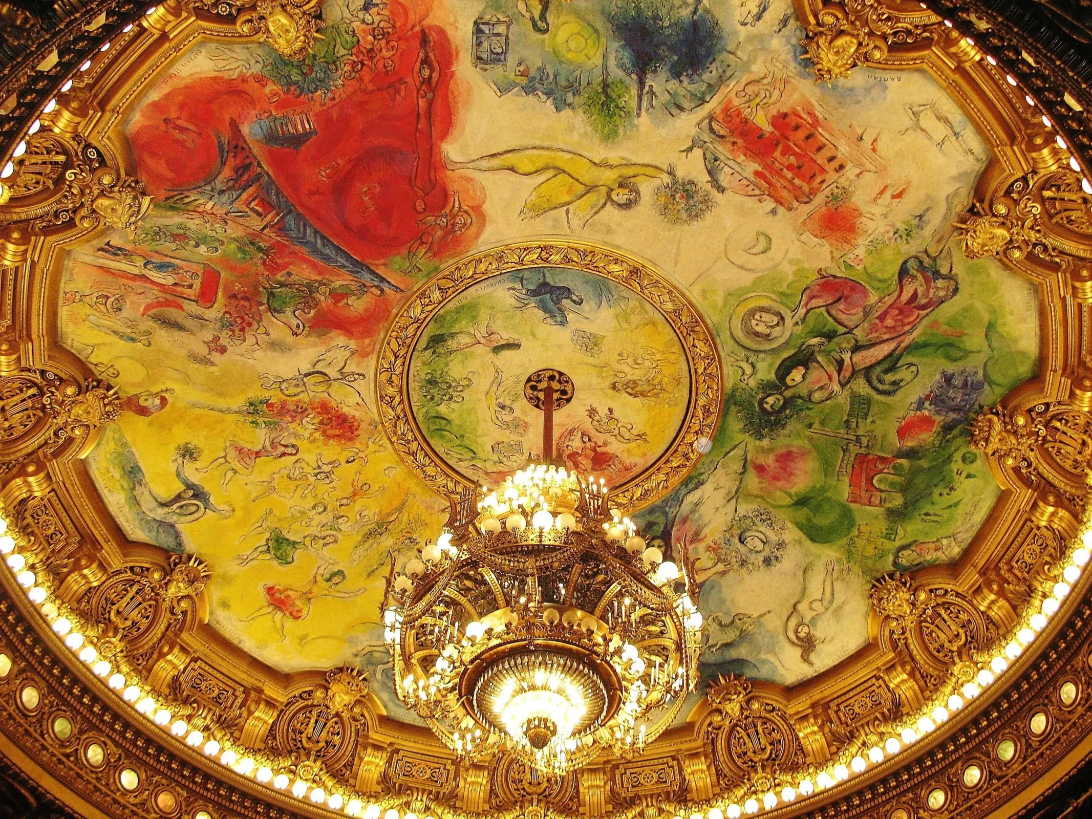 This image depicts the famously controversial painted ceiling of the Palais Garnier in Paris. Artist and Commission: The ceiling was painted by Marc Chagall and inaugurated on September 23, 1964.