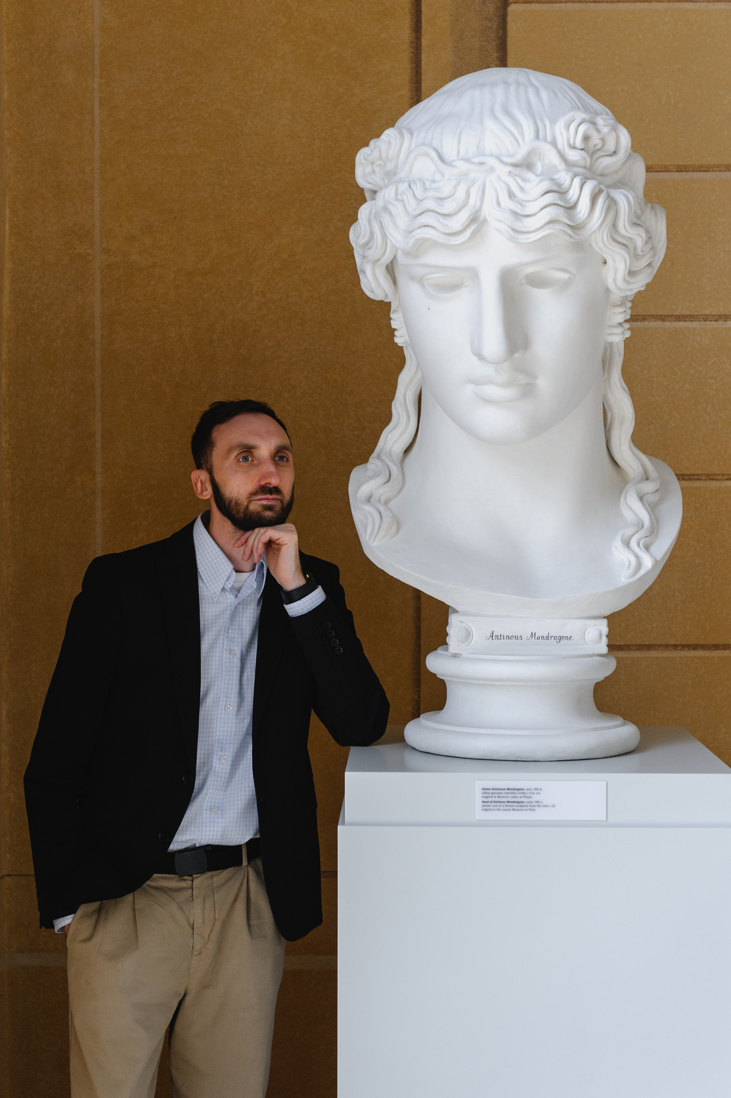 Cultural scholar Dmitry Solodkiy with a sculpture of a giant Greek head. The Royal Baths Museum in Warsaw.