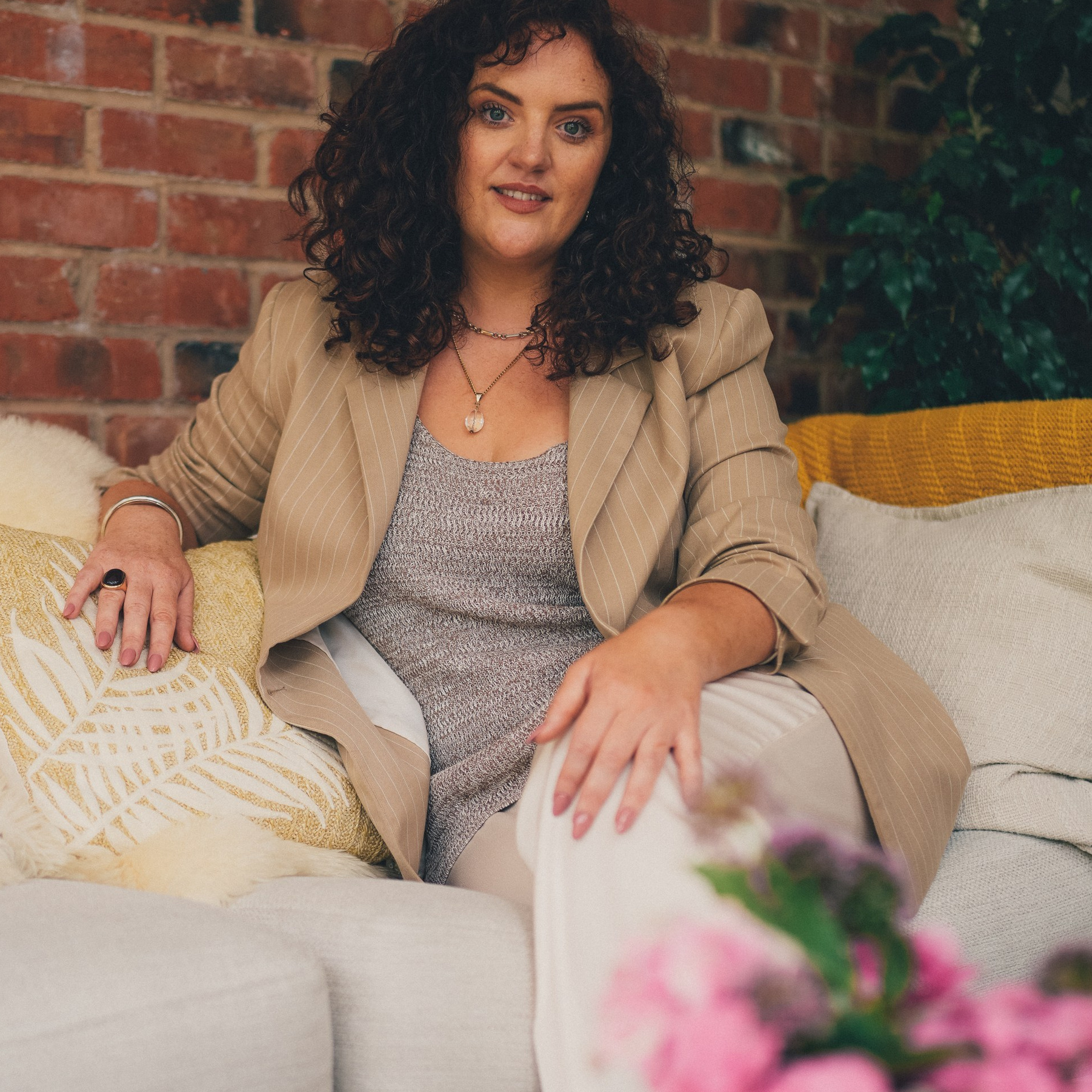 Brand photography session with a counsellor in Solihull, natural lifestyle portrait on a sofa in soft light.