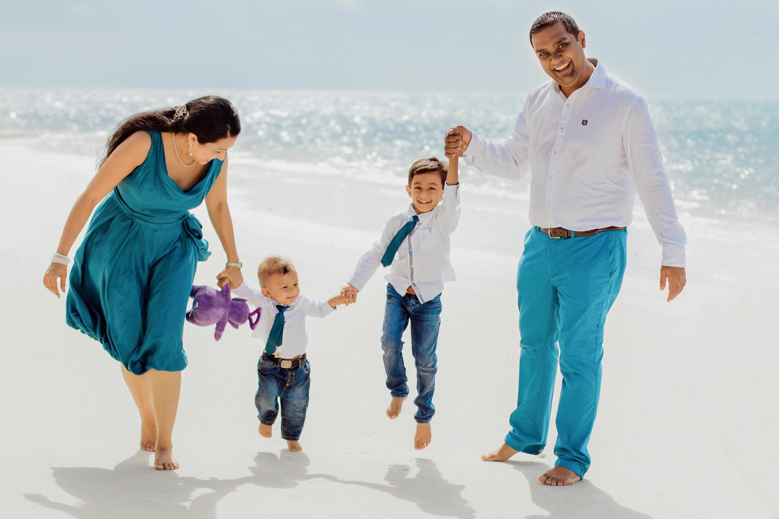 Parents and childrens walking hand-in-hand along the sandy shores of Diani Beach—documenting love, laughter, and connection through soulful family photography.