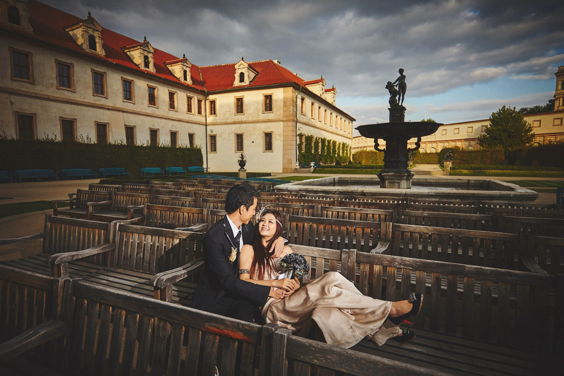 A silhouette of a couple embracing as they look across the Charles Bridge towards Prague Castle.