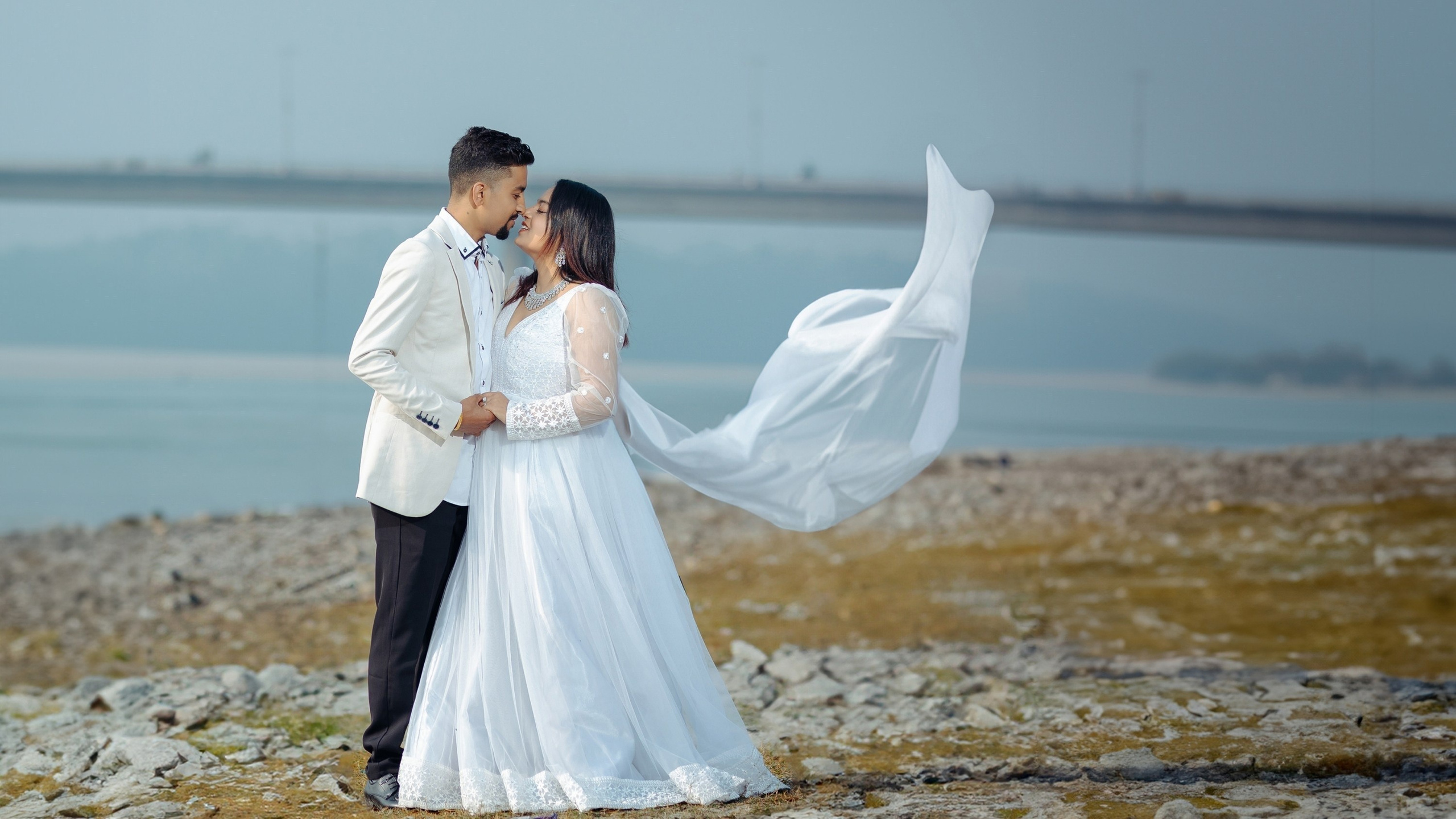 Romantic pre-wedding photoshoot at Narayani river bank Chitwan with a flying white veil, outdoor couple photography