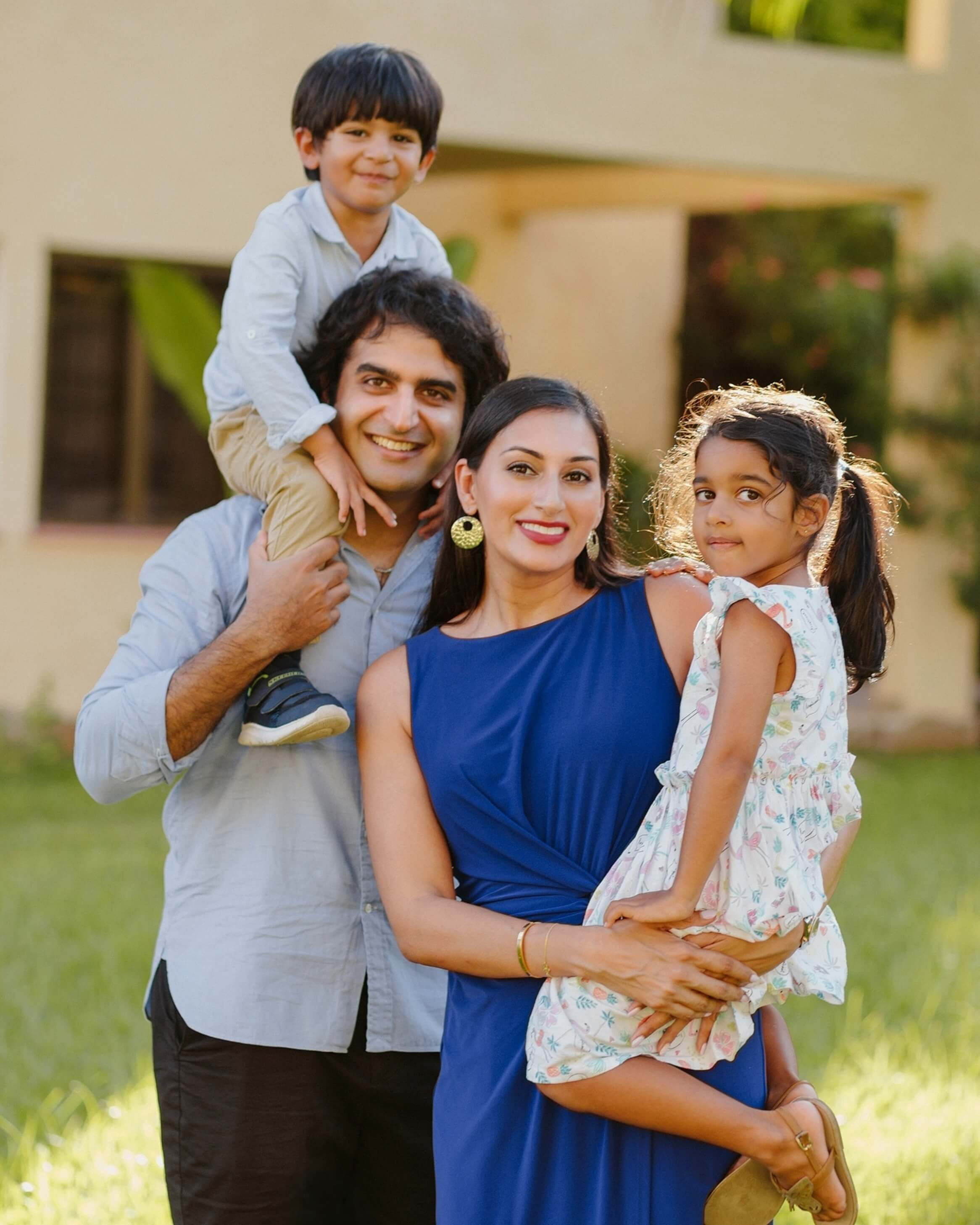 Family of four cuddling and laughing during a lifestyle photo session in Mombasa, Kenya—celebrating togetherness through vibrant and soulful imagery.
