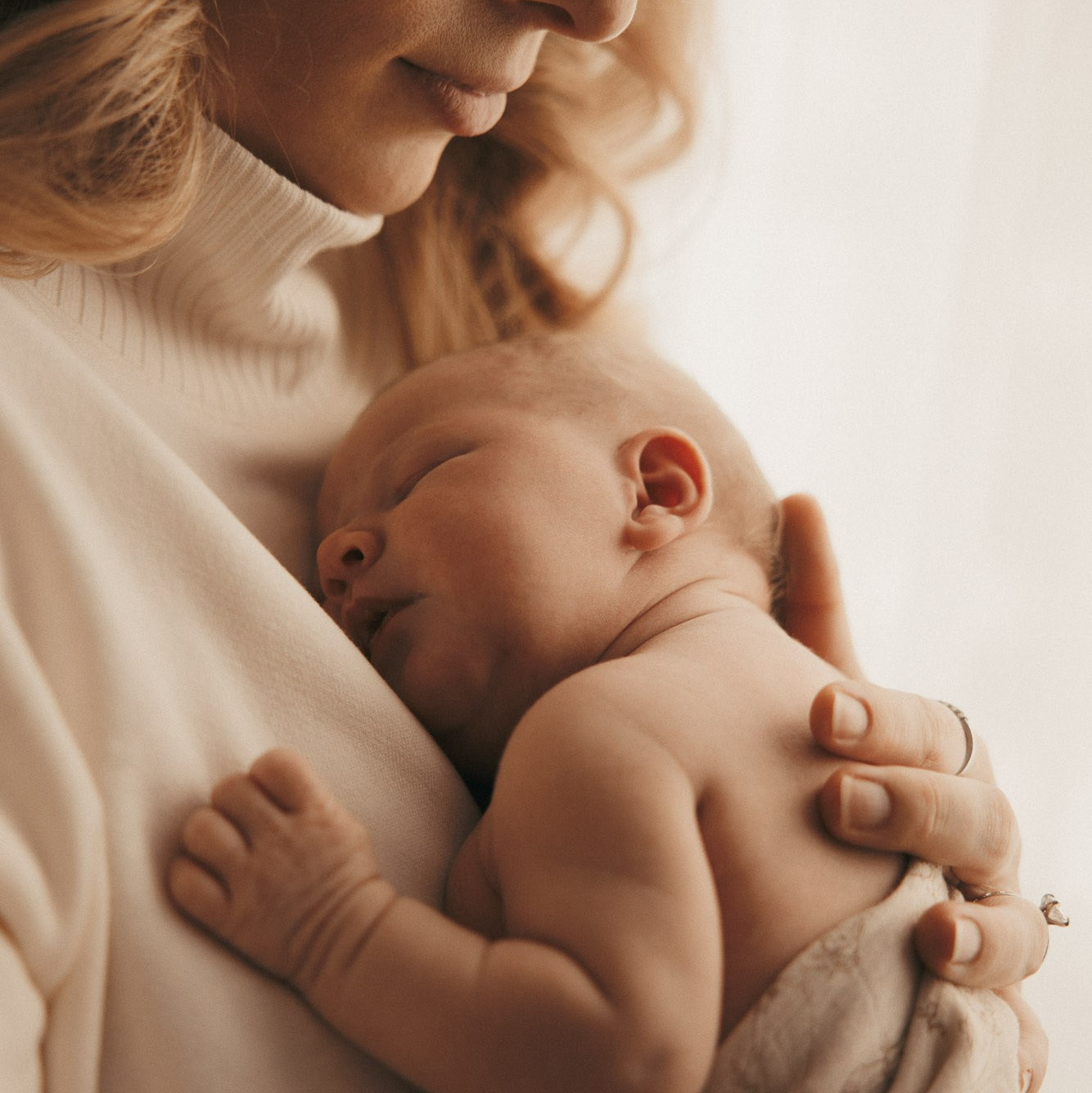 Parents holding their newborn baby during an in-home photography session in Montreal