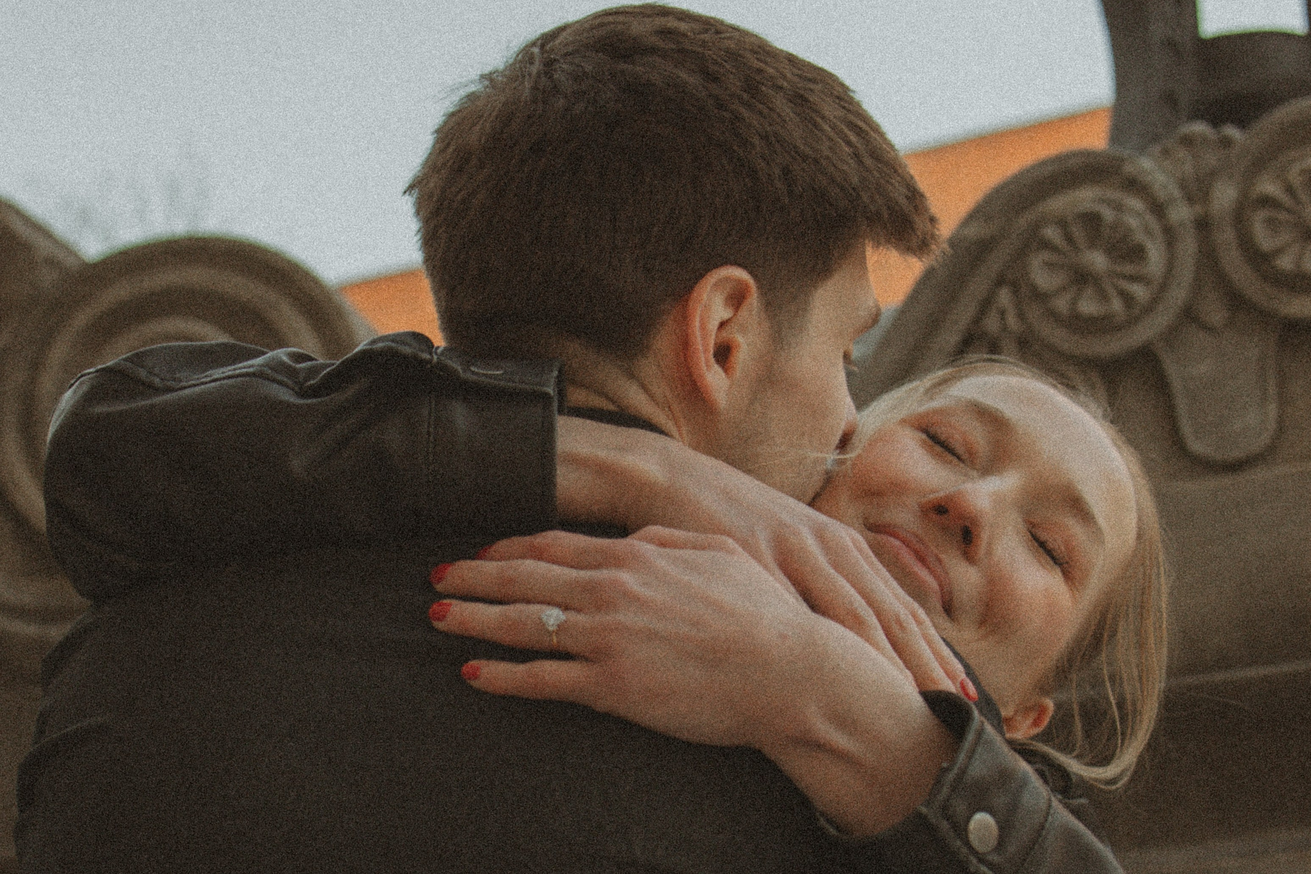Couple hugging during romantic engagement photo session
