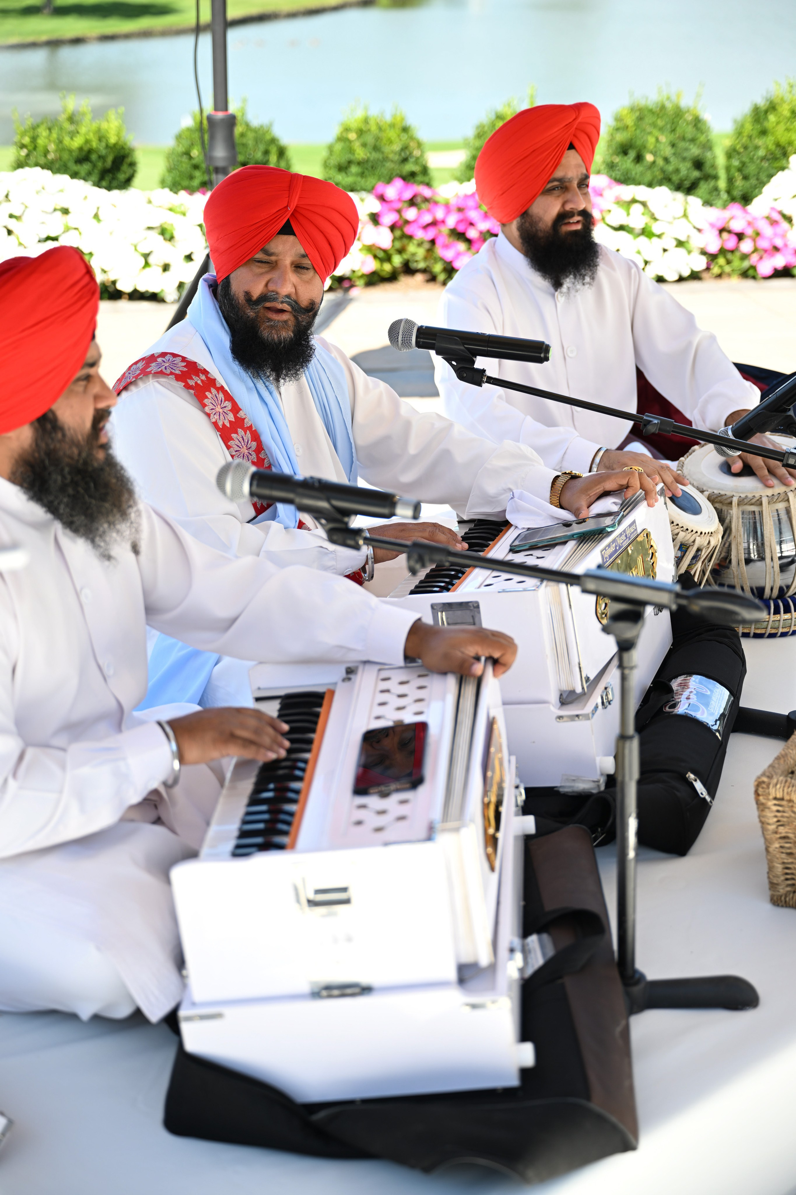 a group of men sitting around a table playing instruments