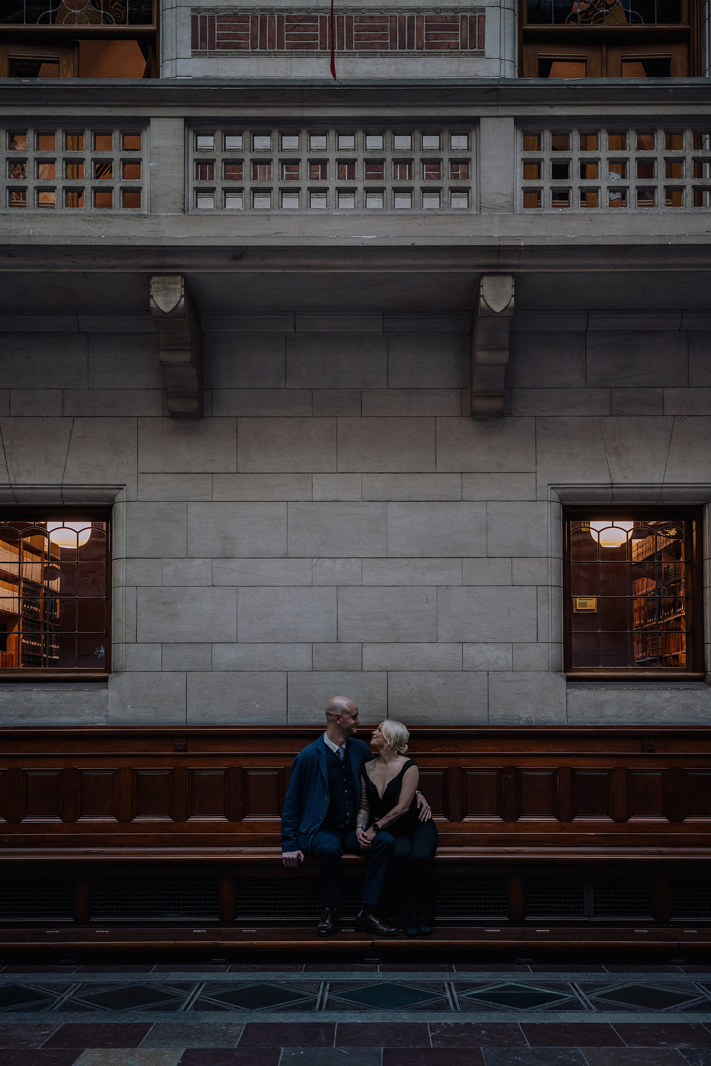 Couple standing close, enjoying a tender moment in Copenhagen City Hall