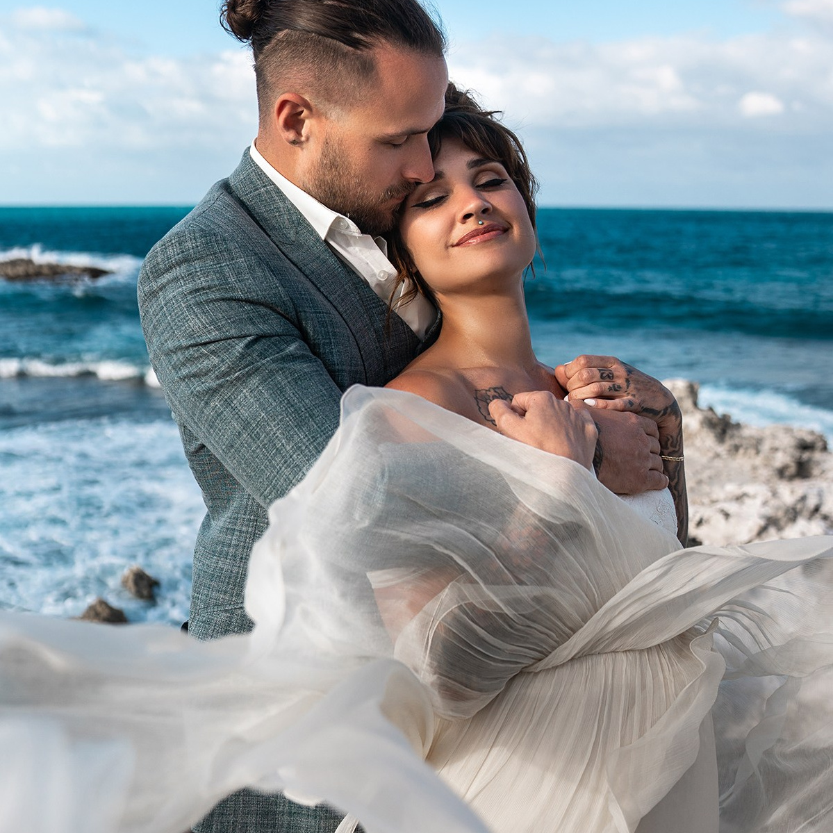 The bride and groom embrace at a wedding in Mexico.