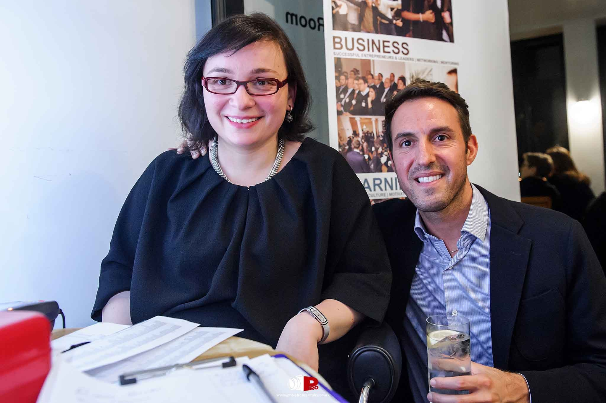 Smiling woman and man enjoying a professional networking event in London.