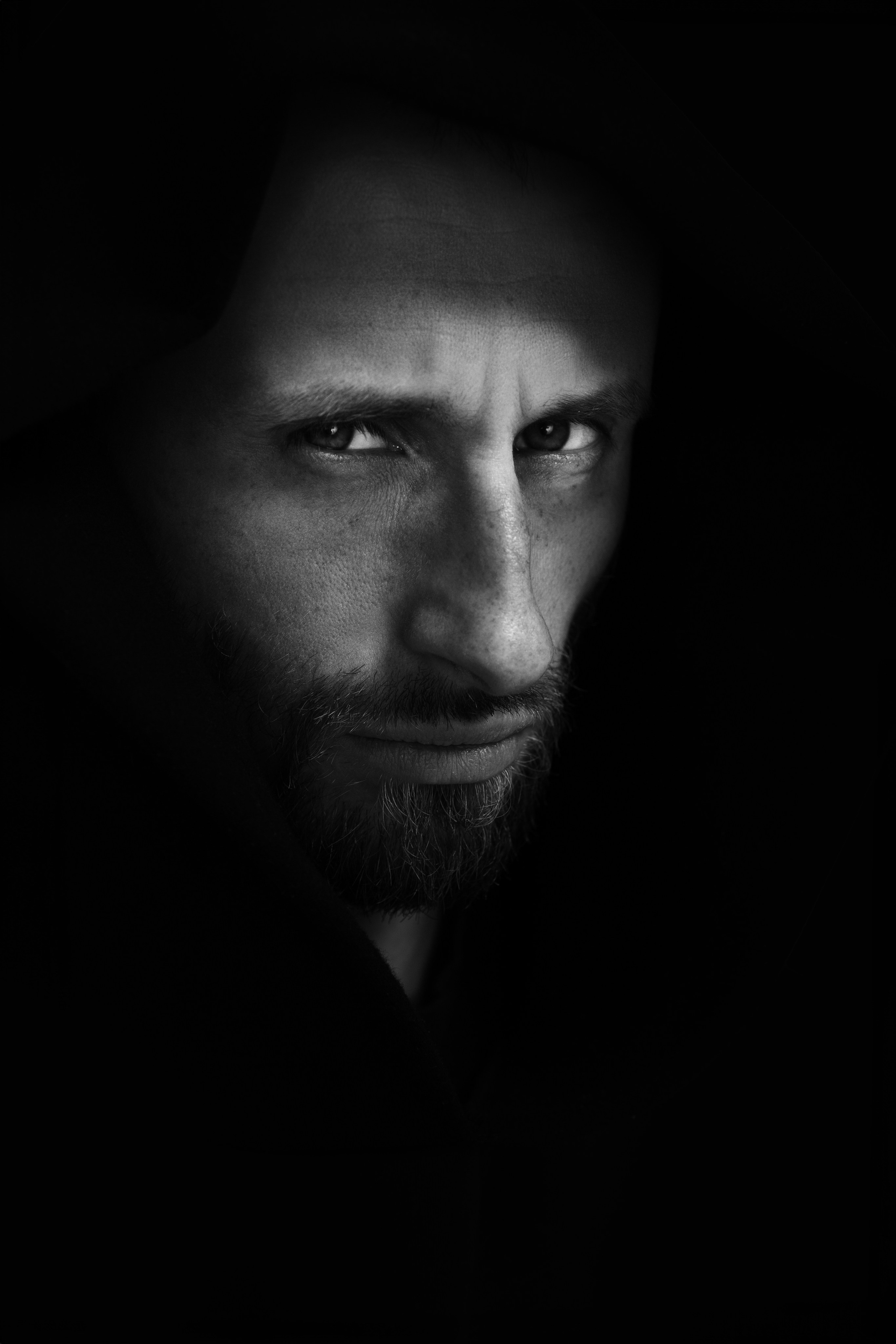 Studio dramatic lighting portrait European photographer. 