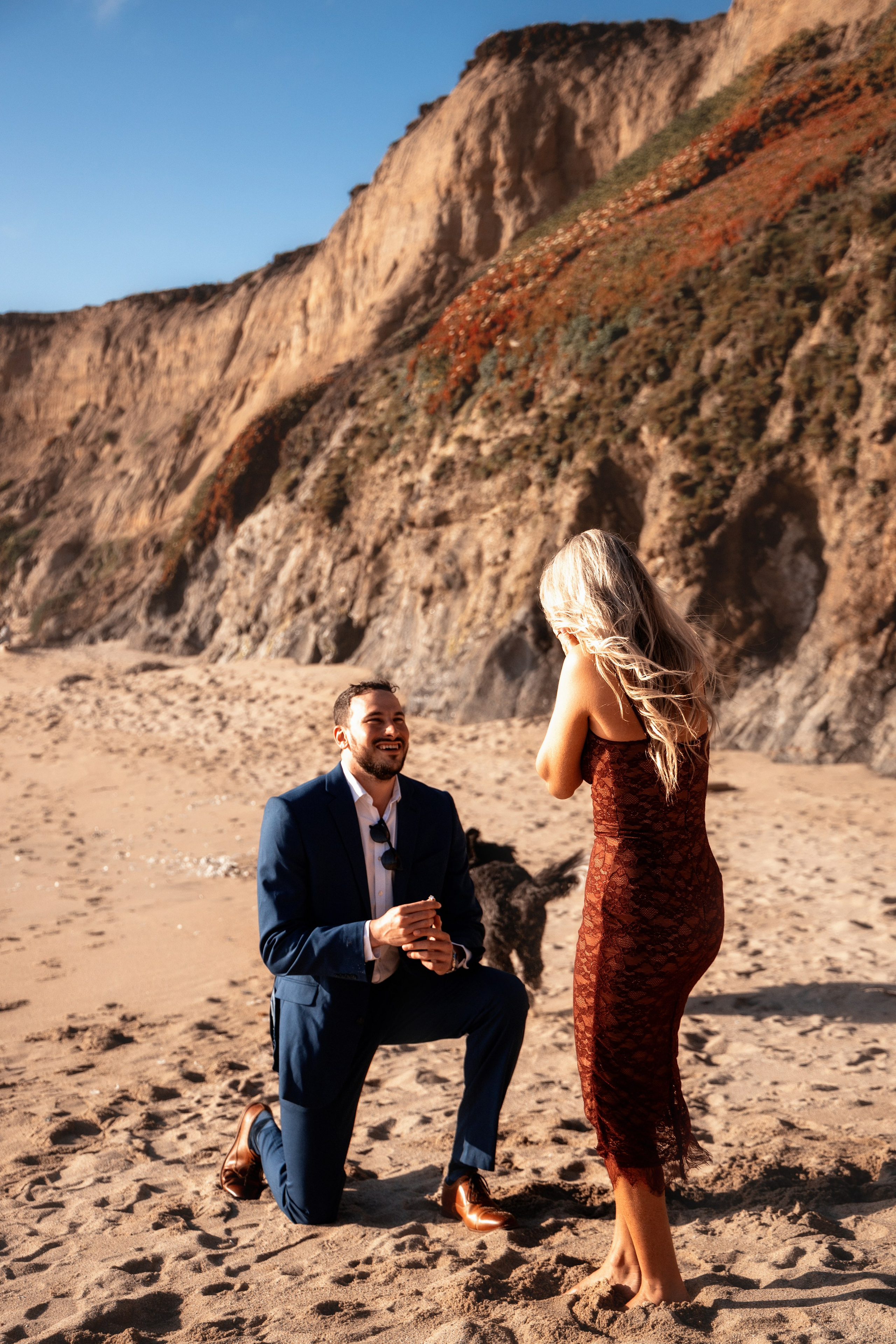 Groom on one knee in front of his bride during a proposal in the Bay Area