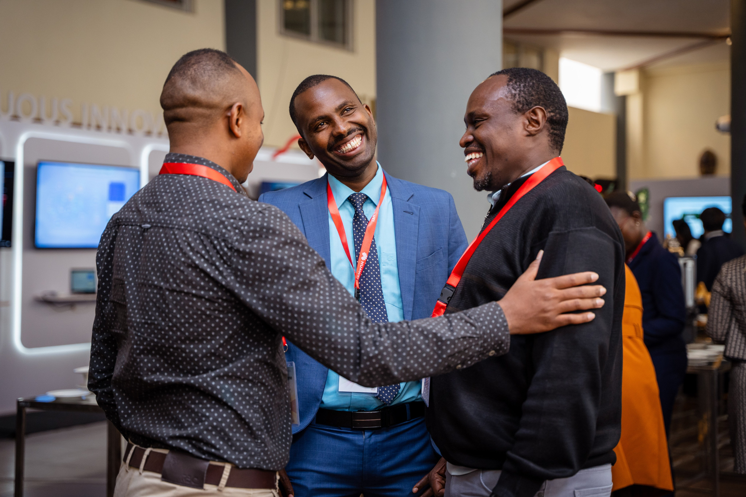A portrait of three men networking at a corporate event in Nairobi.