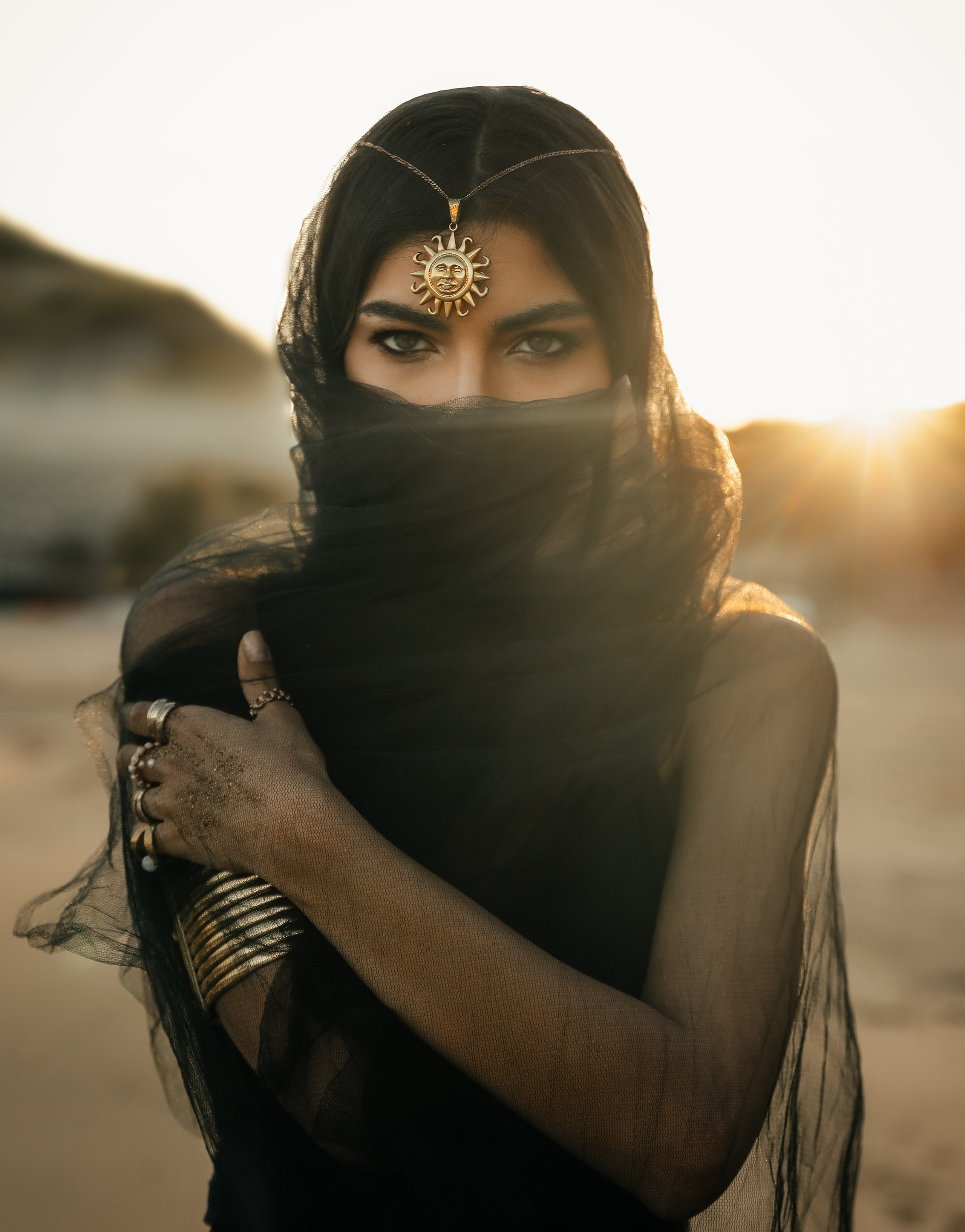 A chic girl in a black dress in the Desert against the setting sun. Rhodes island, Greece