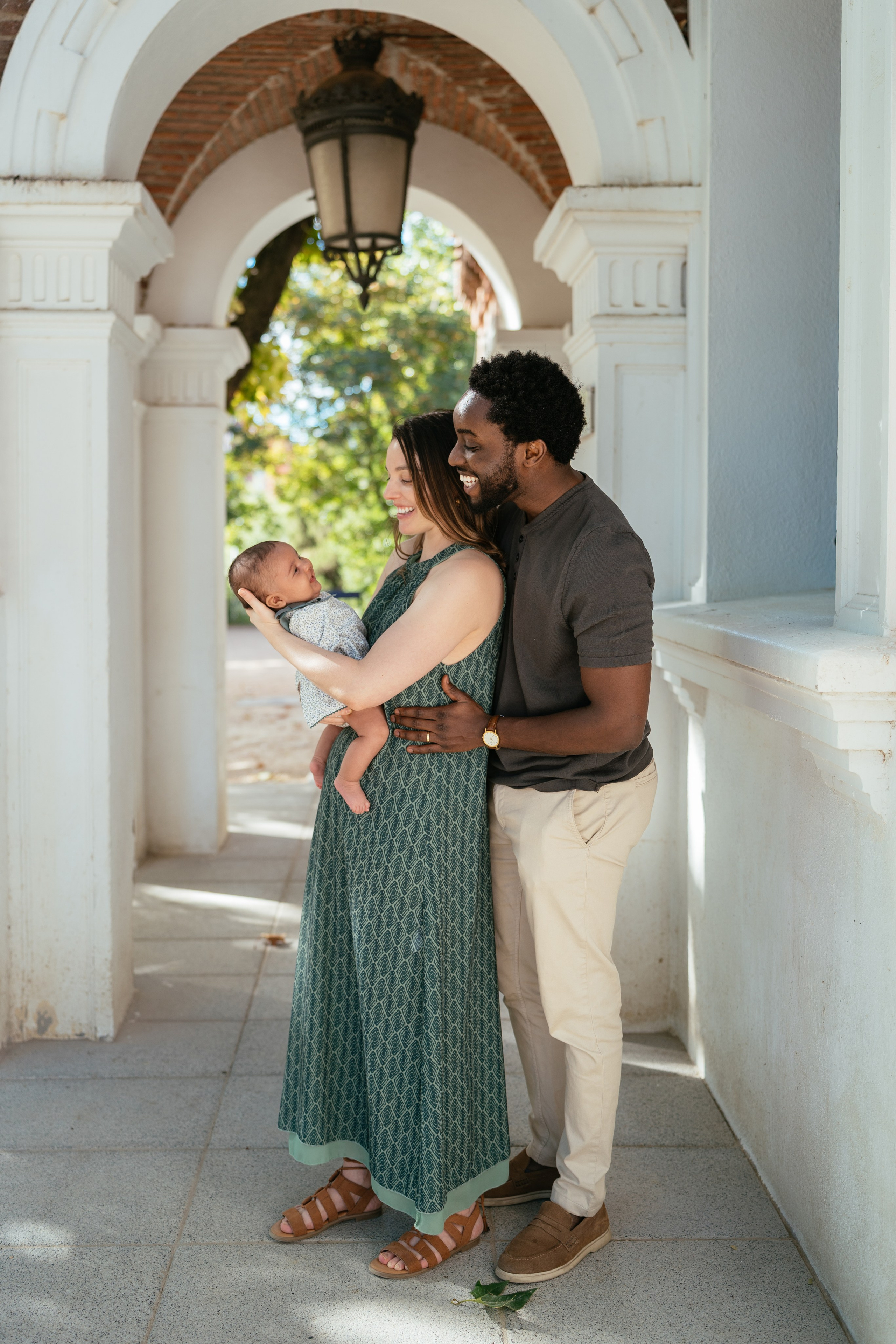 parents gently holding their baby during a candid newborn photoshoot in madrid