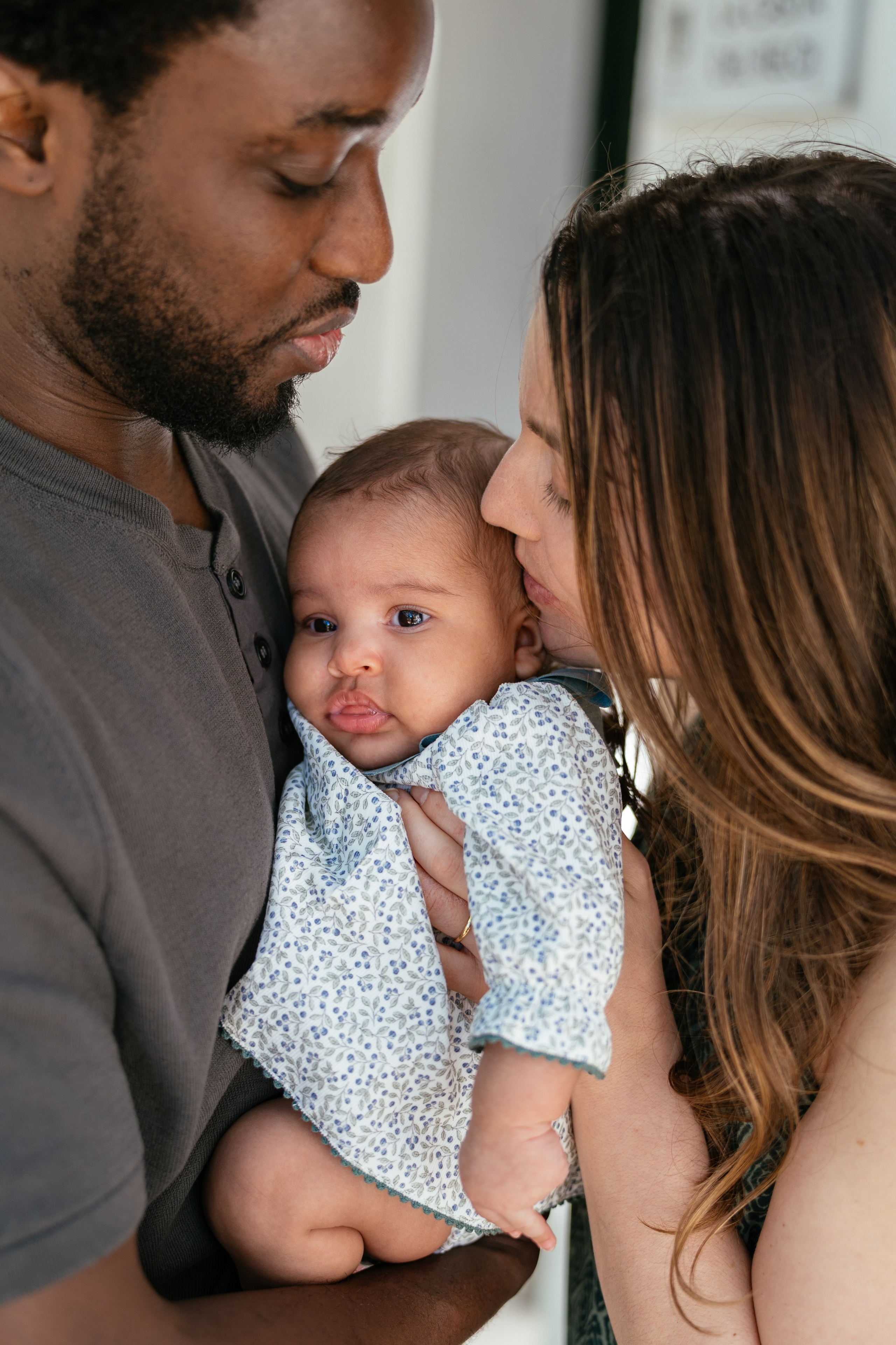 tender unposed family photography with a newborn baby in a comfortable setting