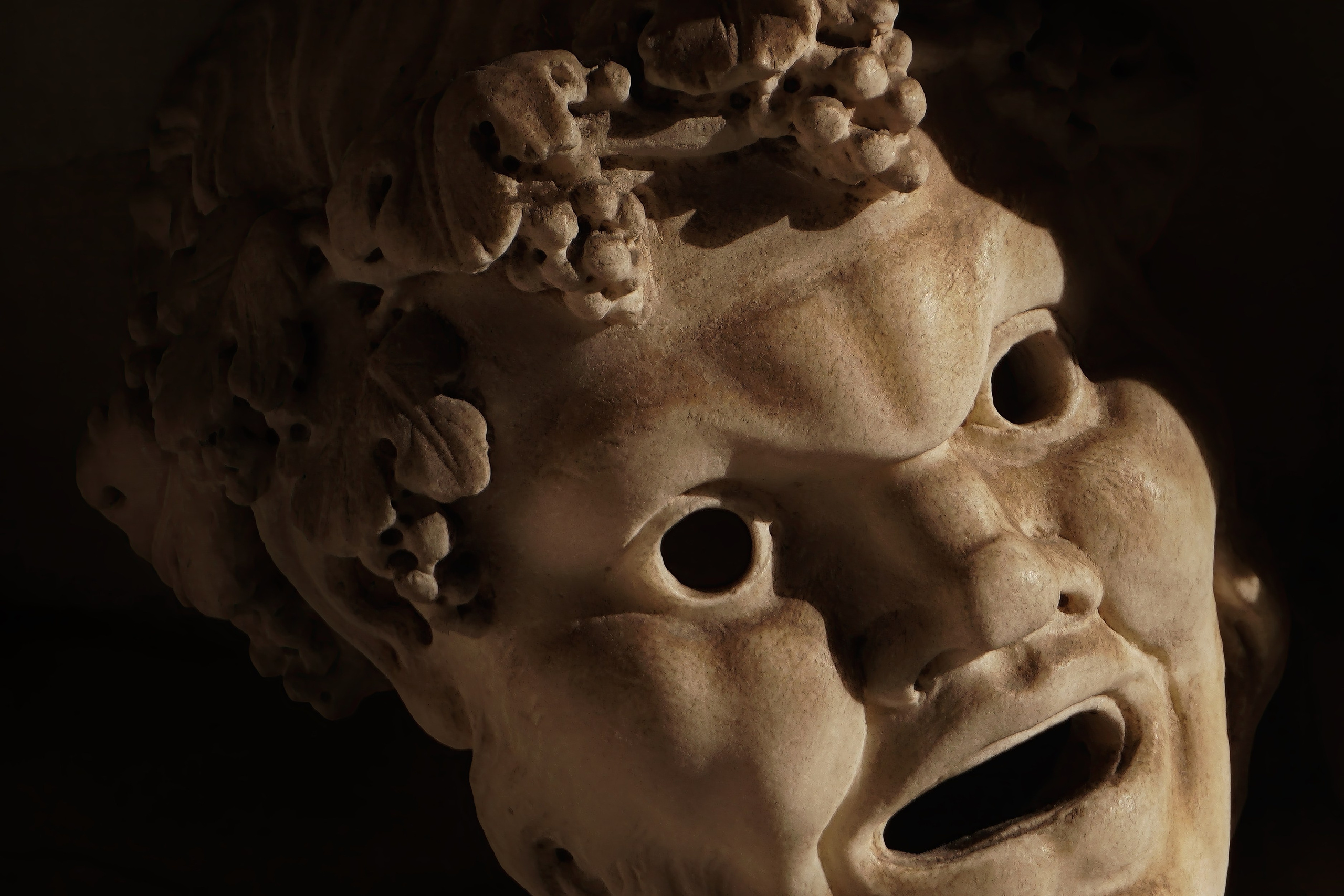 Photography of Italy – Theatrical mask relief in the Vatican Museums in Rome, photographed as part of a photography book about Rome.