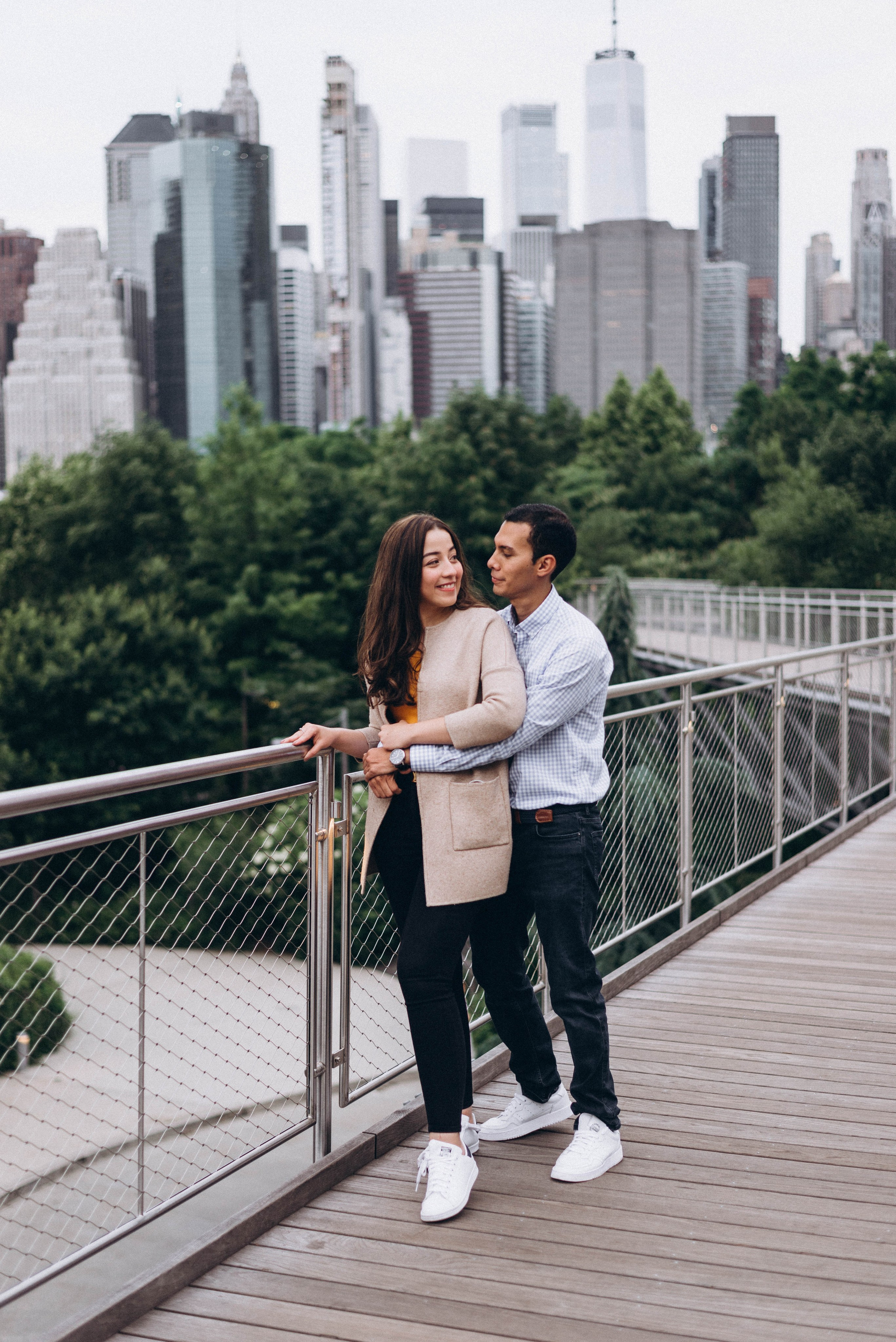 Couple kissing after proposal on Brooklyn Bridge.
