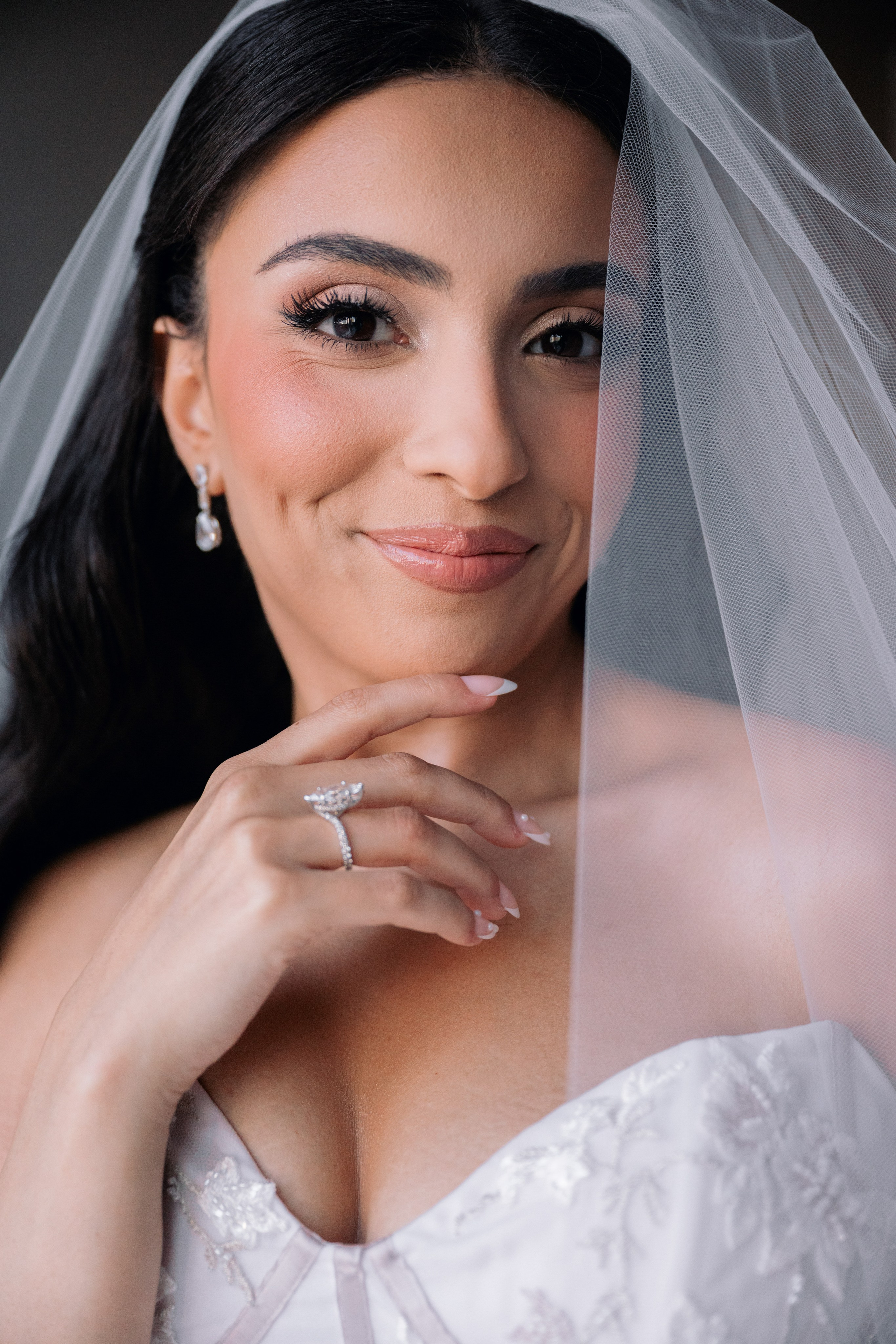 Bride portrait with veil, soft light, and natural makeup