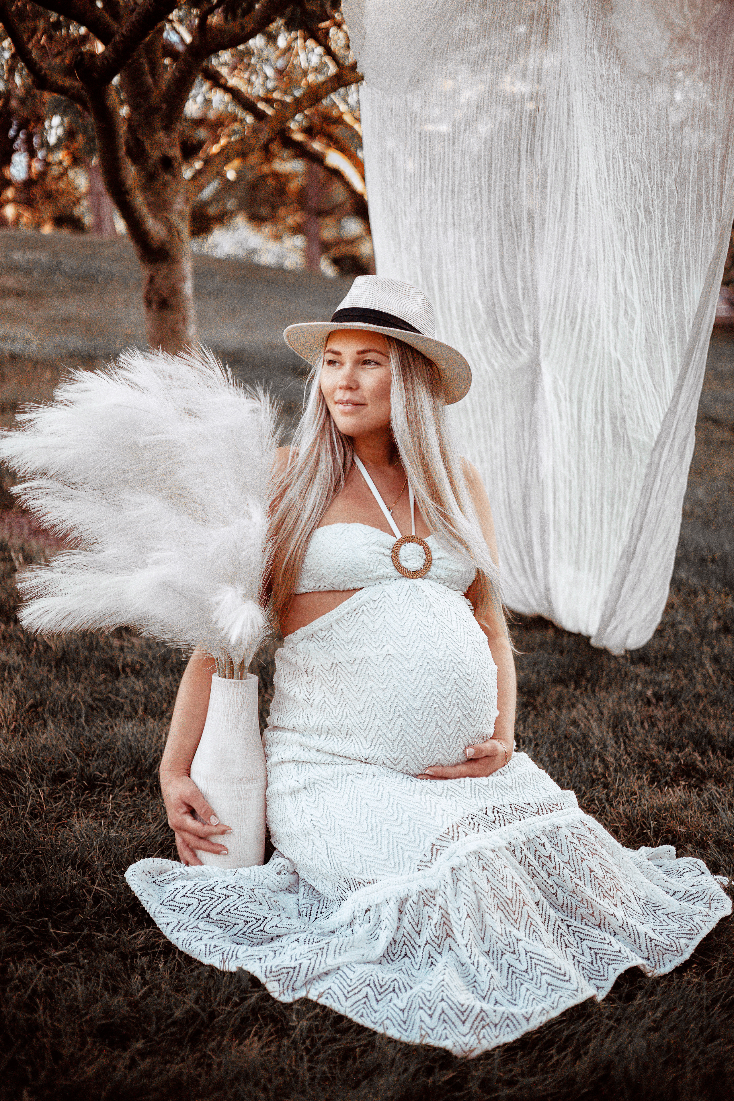 Expecting mother enjoying nature during a maternity photoshoot in the park