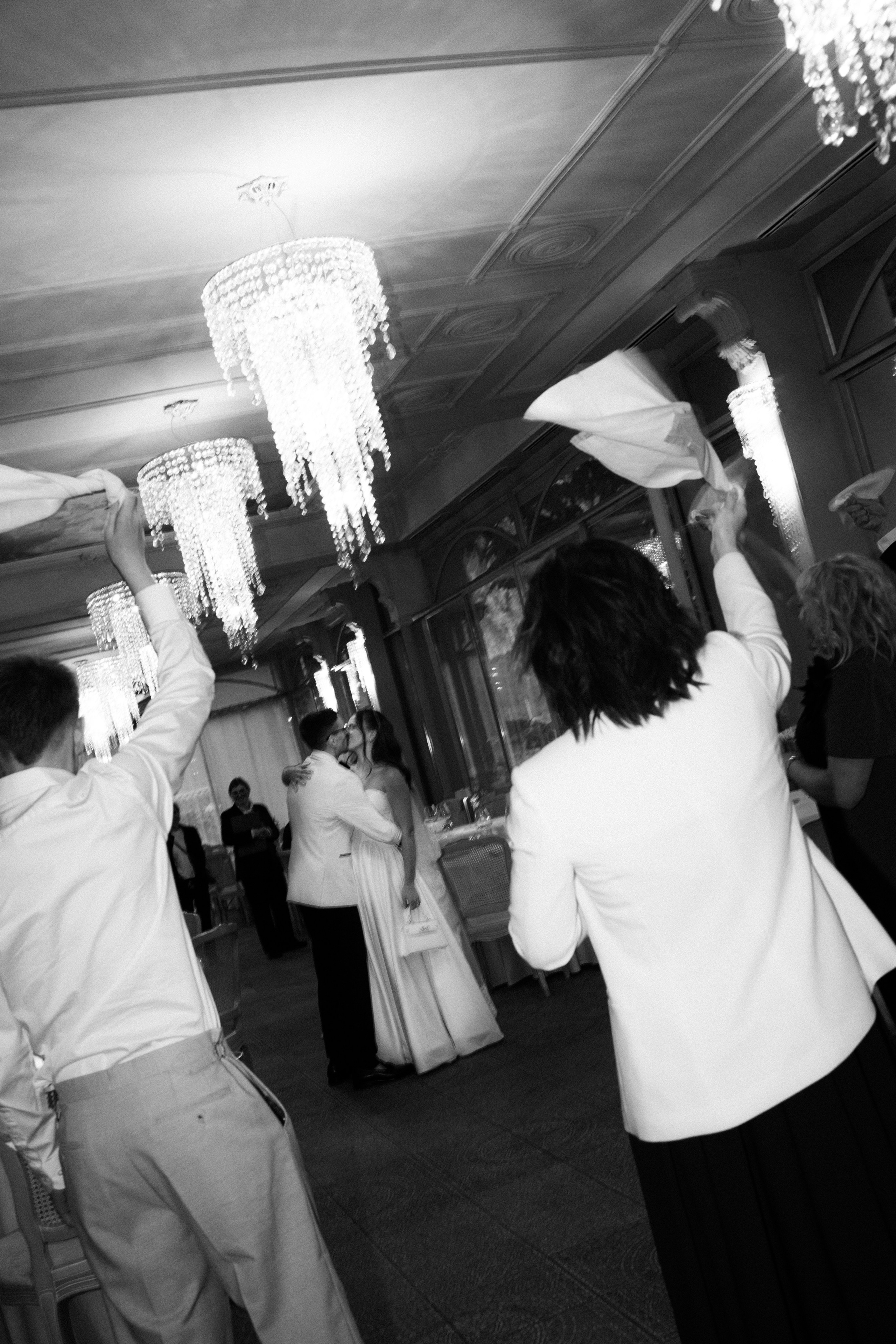 Guests waving napkins while the bride and groom share their first dance at a Lake Como wedding reception