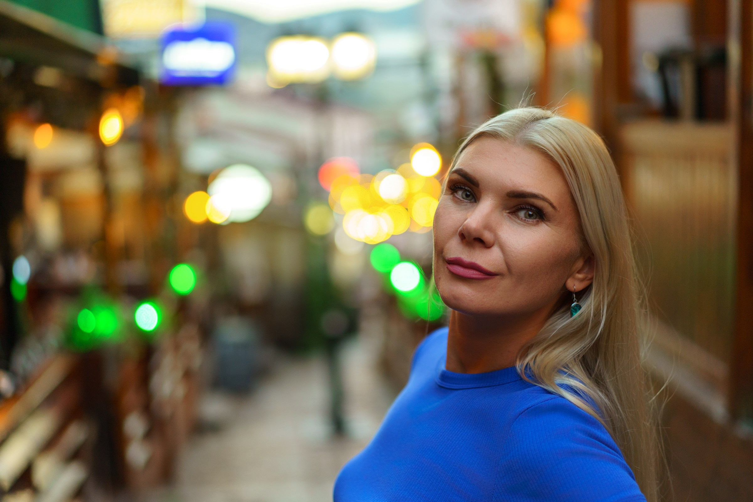 Female portrait photography in Skopje, North Macedonia, evening city lights, cinematic urban portrait
