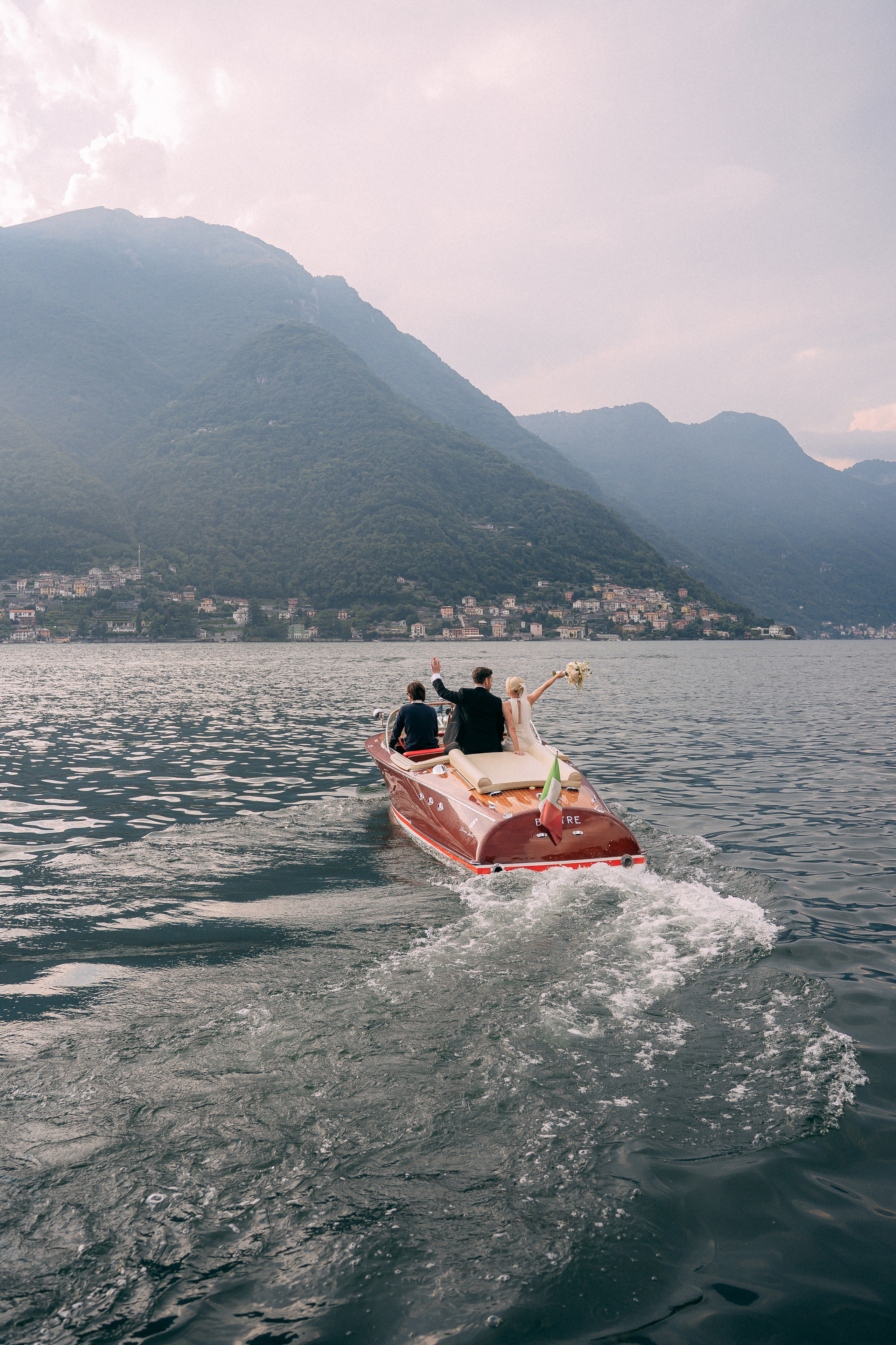 Boat cruising across Lake Como at Villa Lario, Italy