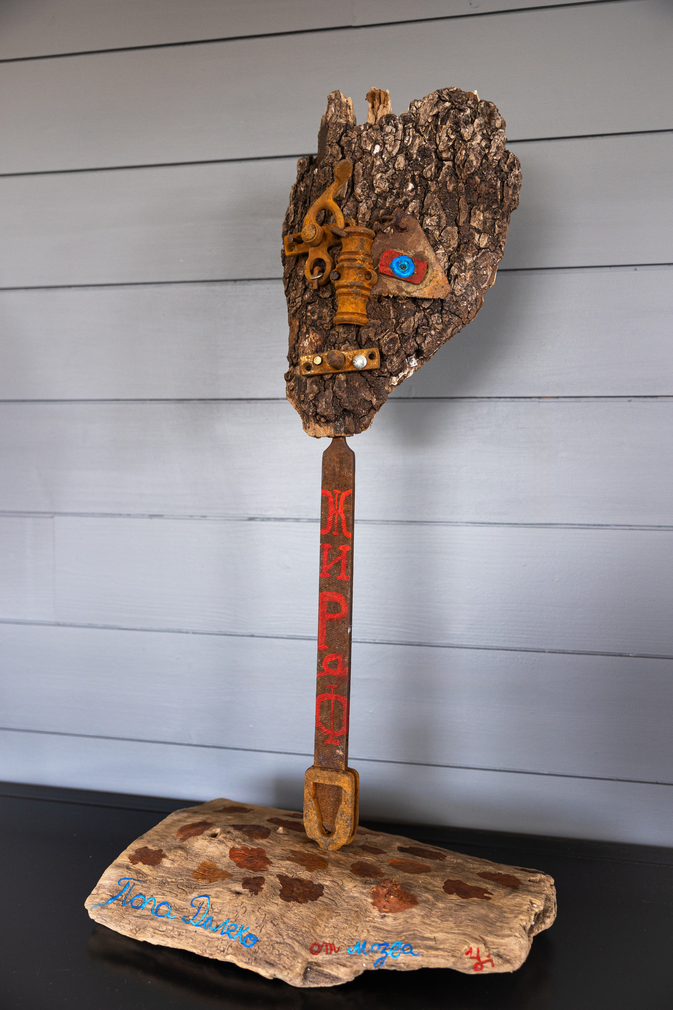 Private joke with a wood human face on a metallic file tool neck 