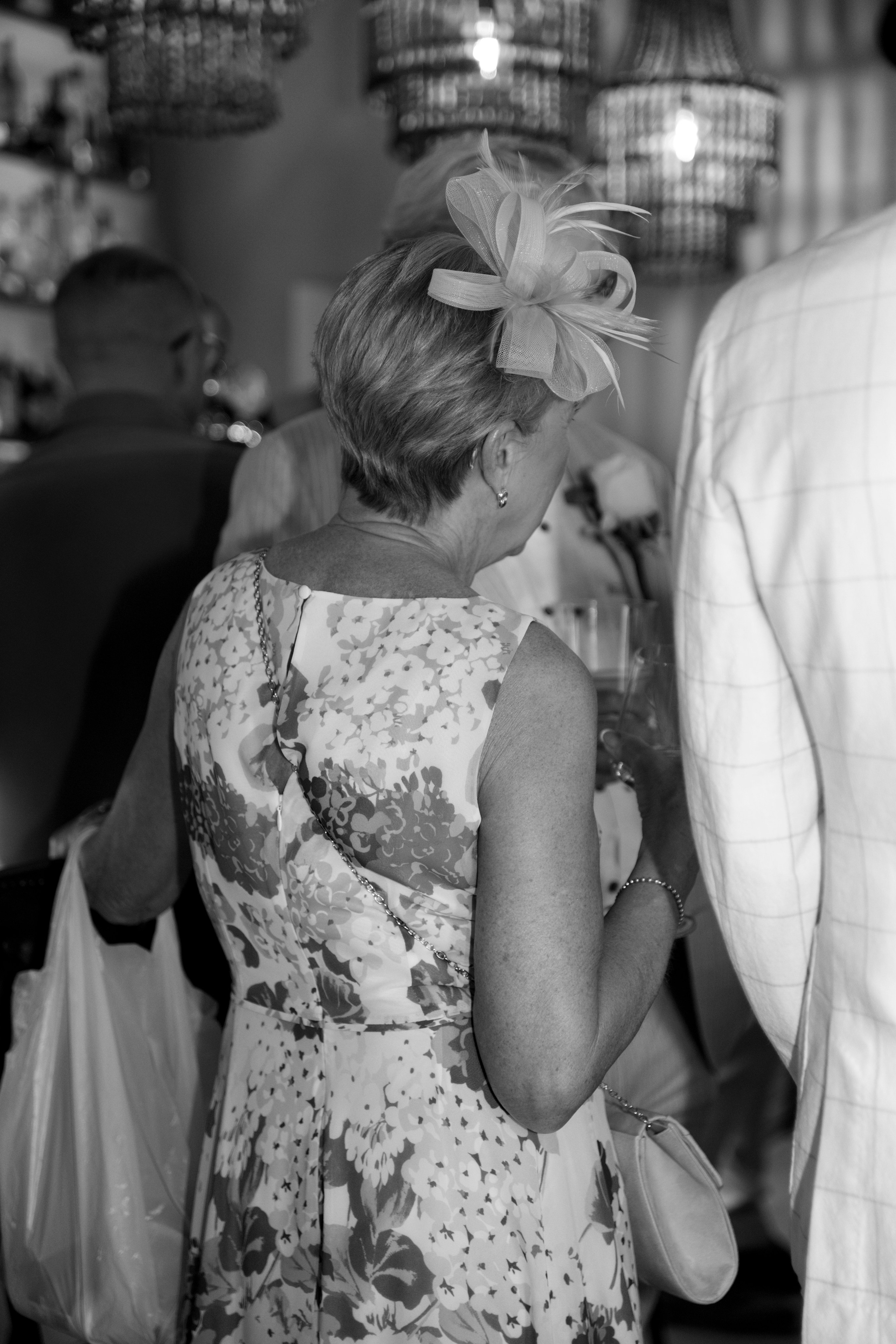 Group of friends enjoying drinks and sharing stories at a pre-wedding party in a charming Lindos bar