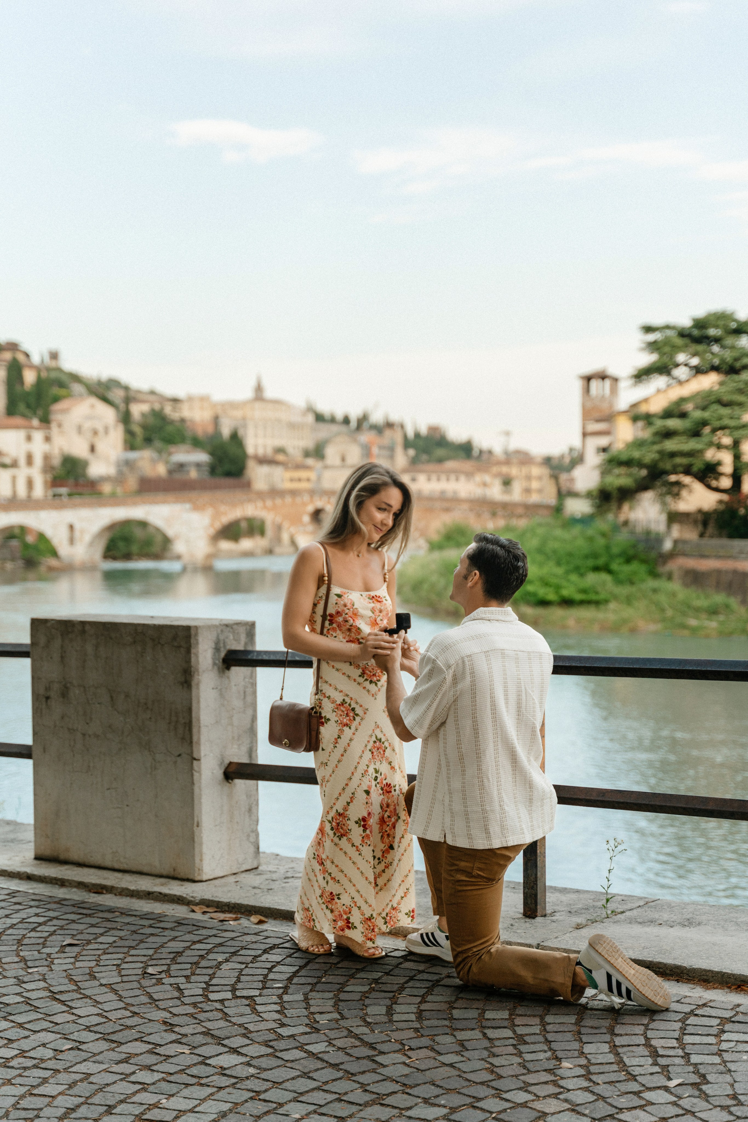 Surprise marriage proposal with Ponte Pietra and Verona in the background.