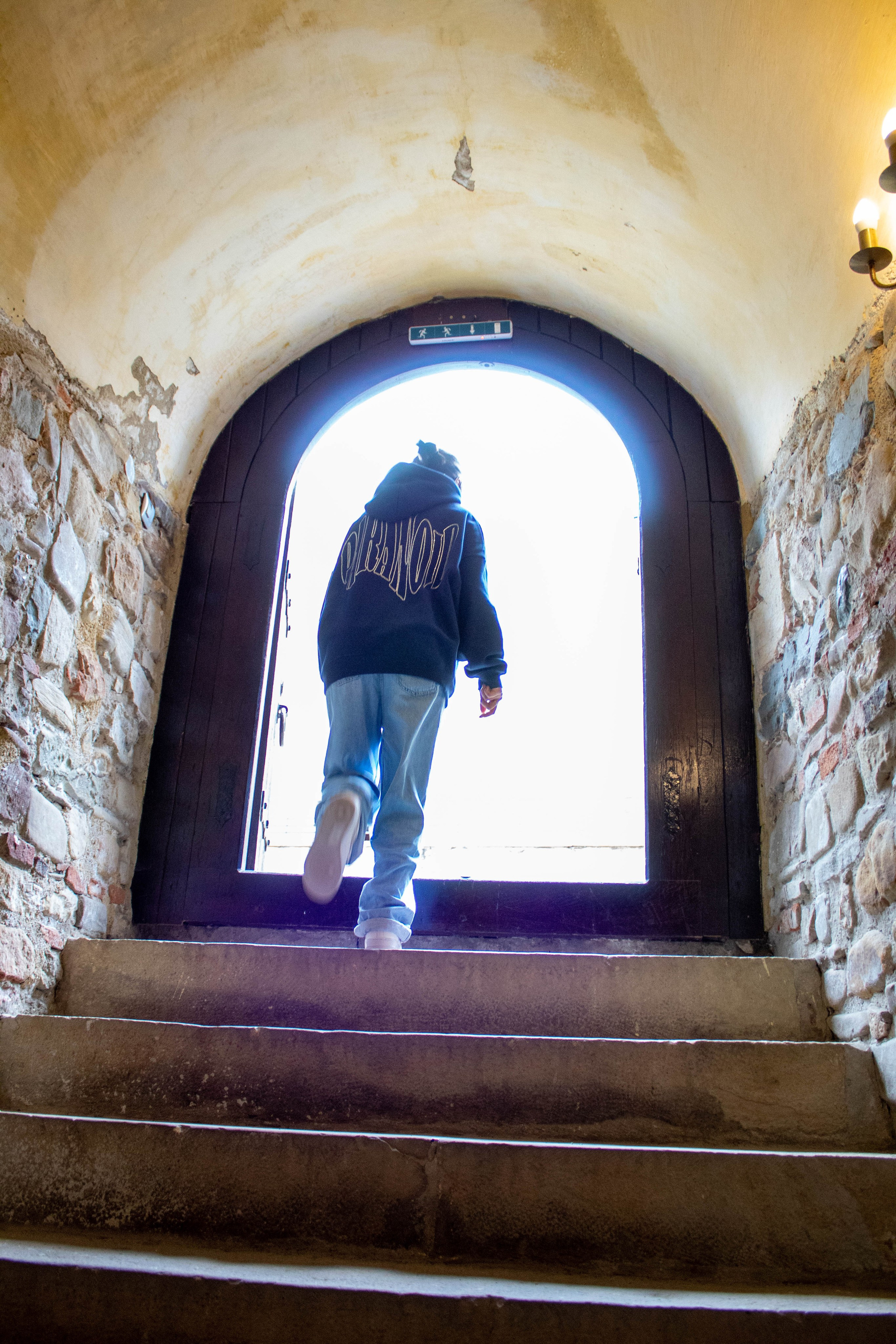 Symmetrical view through a blue arched doorway with diffused lighting.