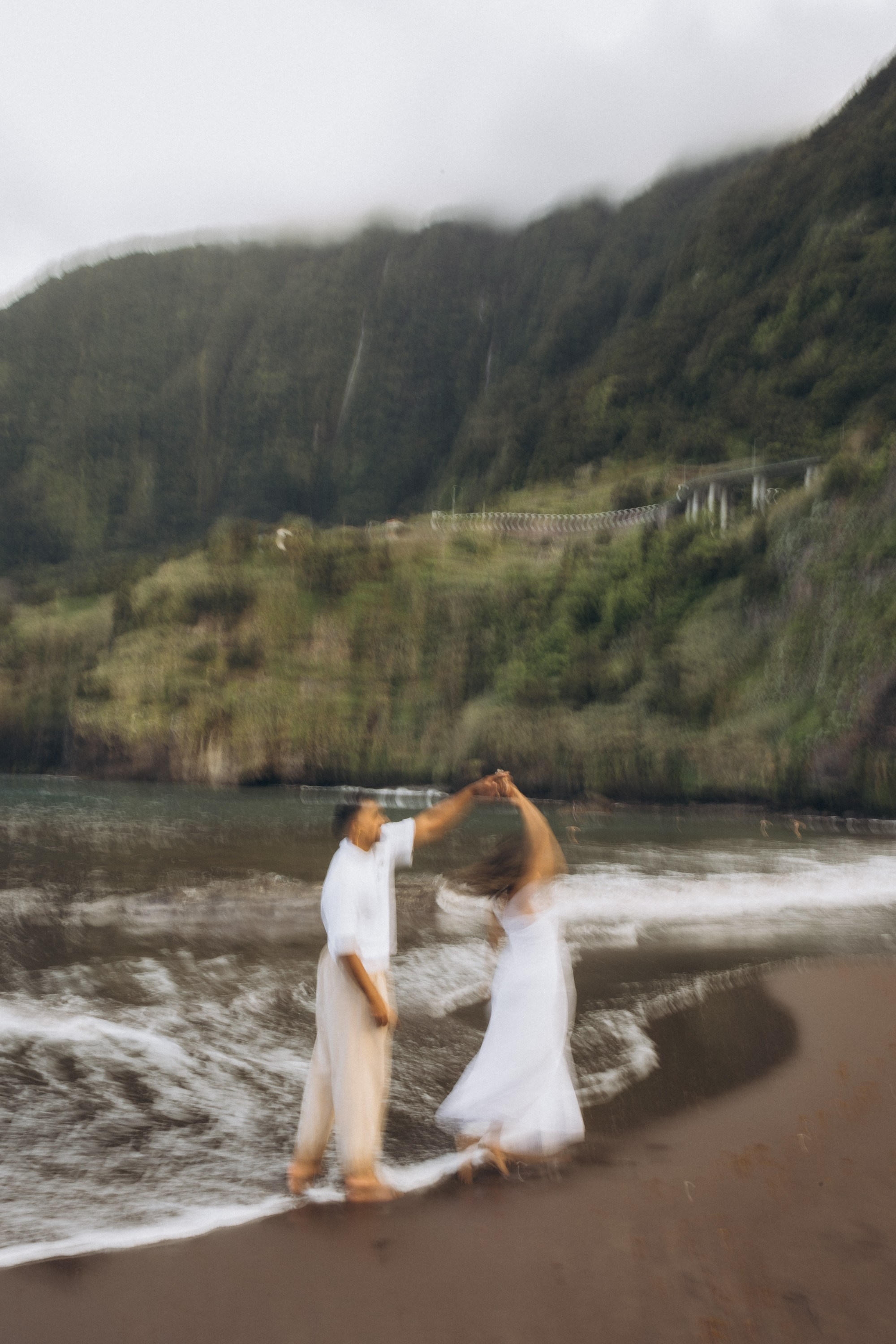 Romantic proposal on Seixal Beach, Madeira — black sand and ocean waves.